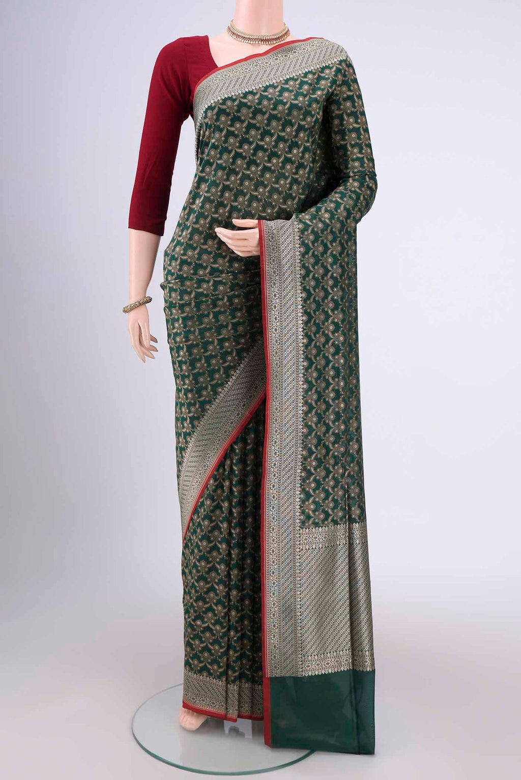 Bottle Green Banarasi Silk Saree with Jacquard With Zari Butta on the body and Zari Border.  displayed on a mannequin