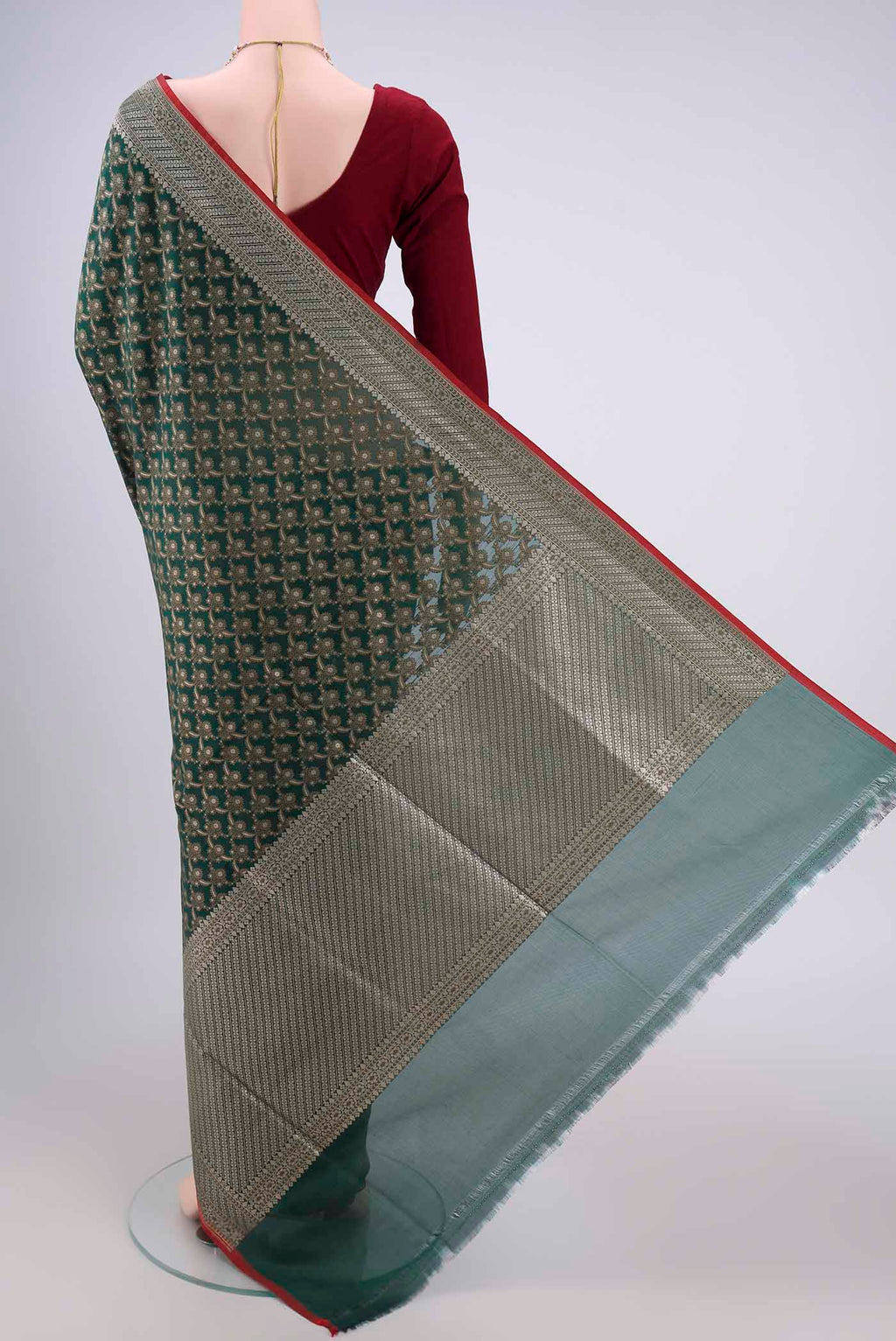 Flat view of Bottle Green Banarasi Silk Saree with Jacquard With Zari Butta on the body and Zari Border. 