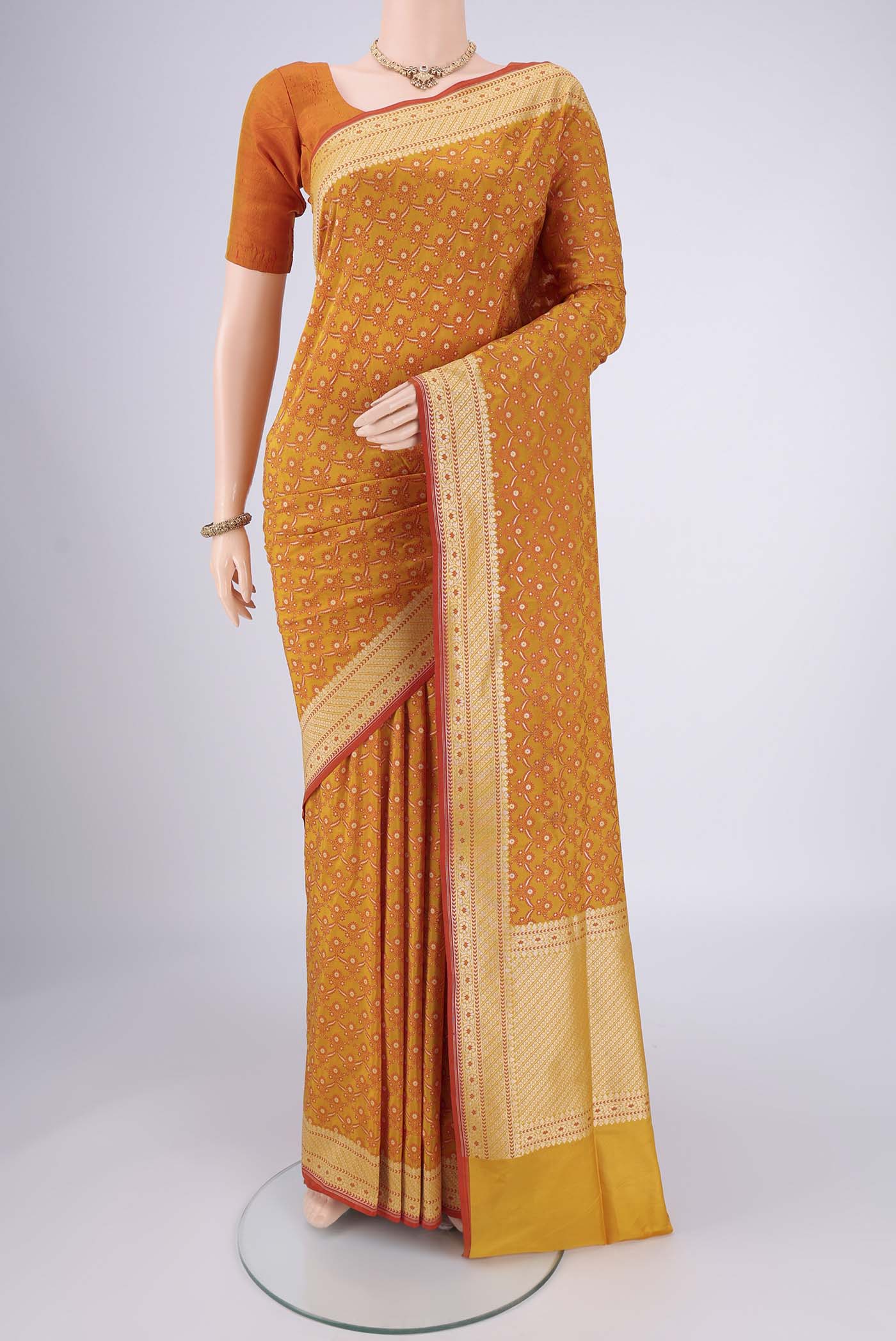 Mustard Banarasi Silk Saree with Jacquard With Zari Butta on the body and Zari Border.  displayed on a mannequin