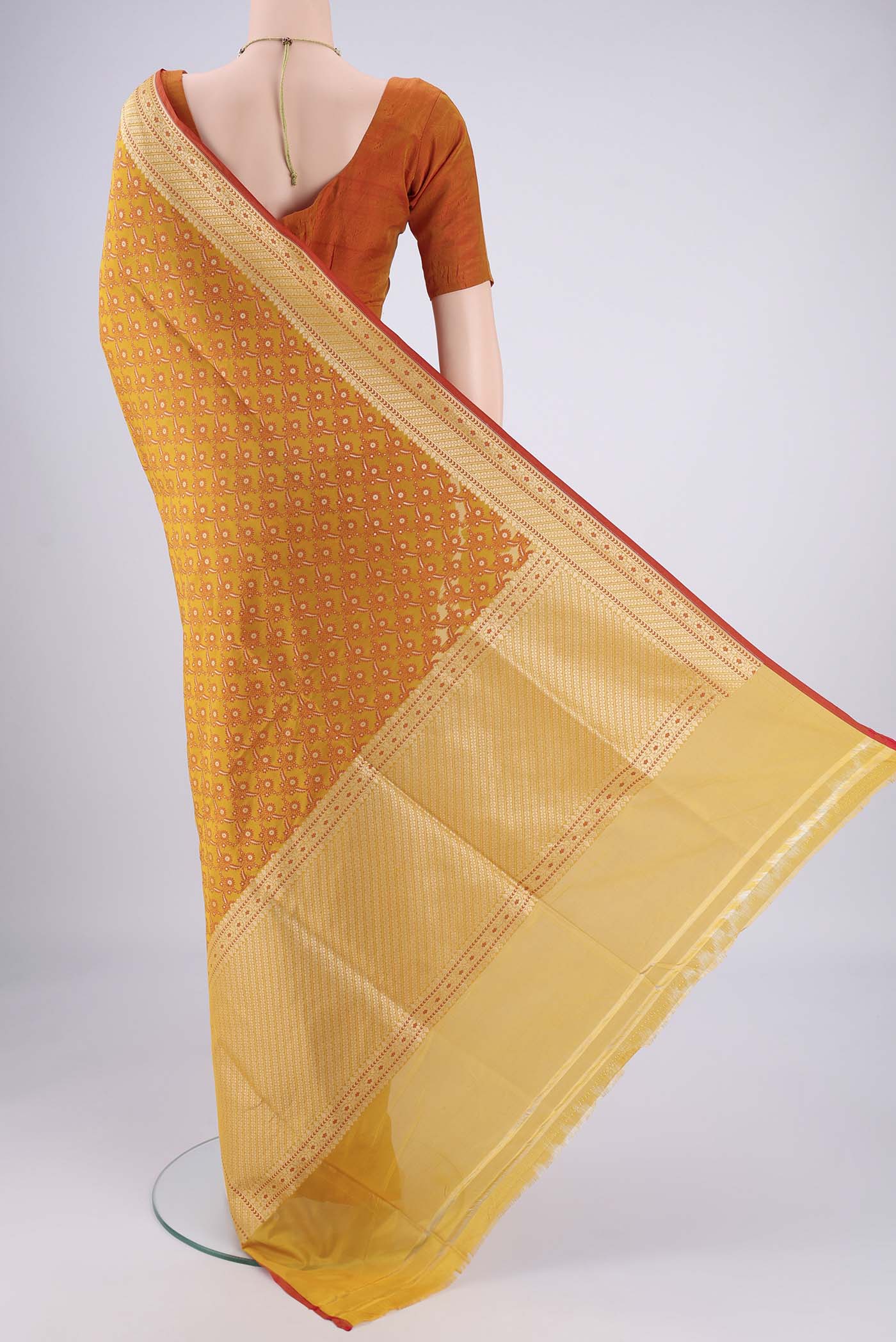 Flat view of Mustard Banarasi Silk Saree with Jacquard With Zari Butta on the body and Zari Border. 