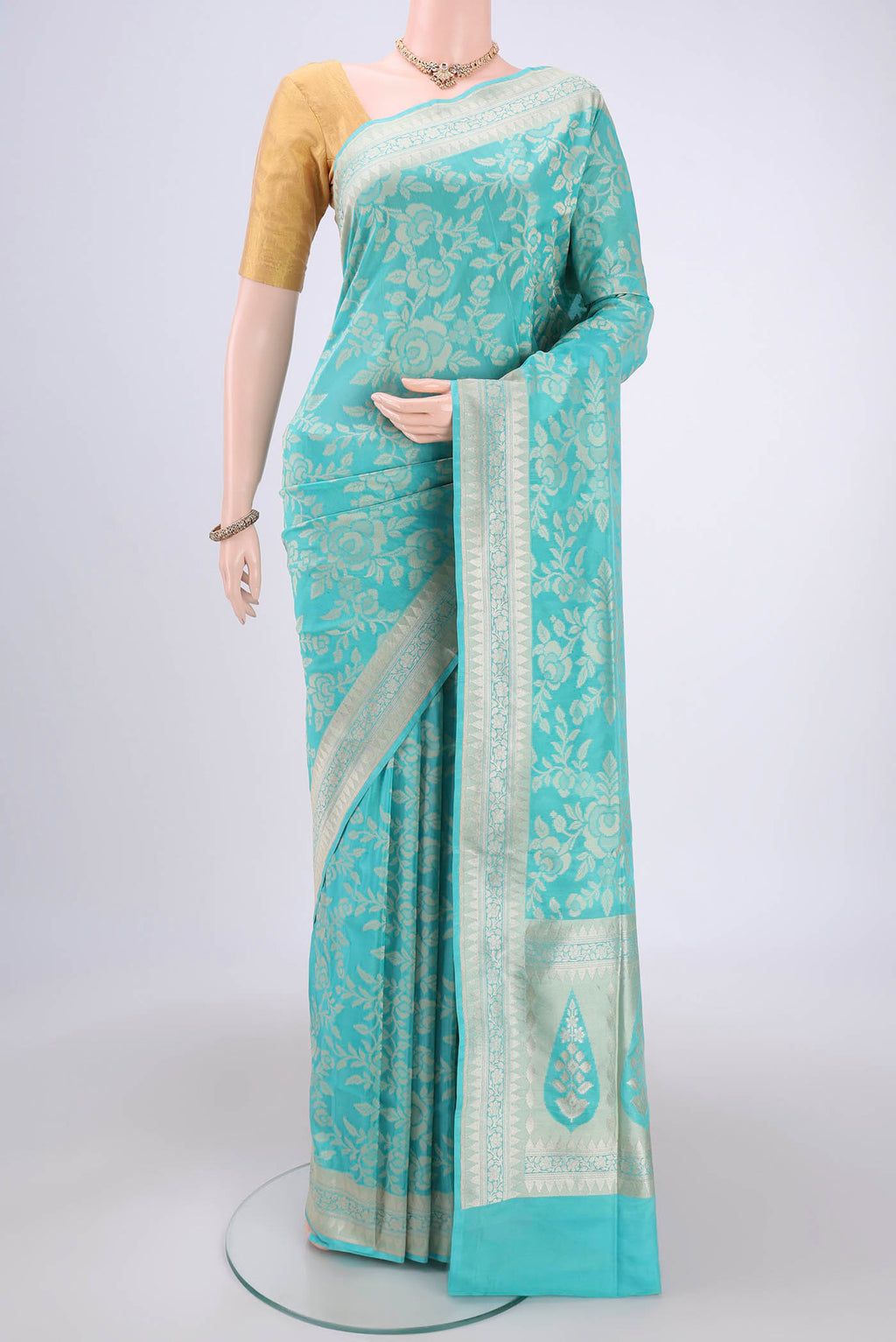 Sky Blue Banarasi Silk Saree with Zari And Thread Butta on the body and Zari Border.  displayed on a mannequin