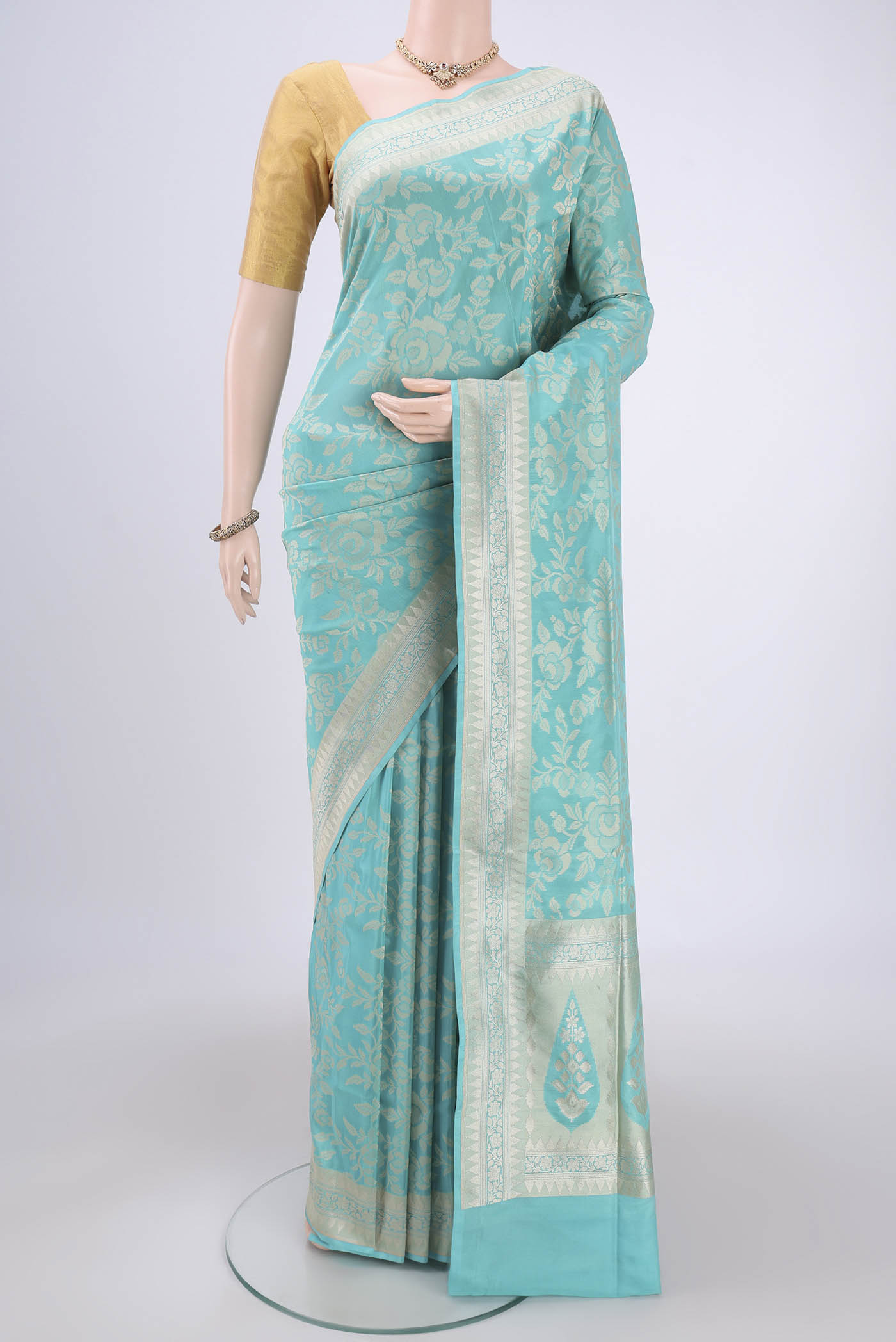 Sky Blue Banarasi Silk Saree with Zari And Thread Butta on the body and Zari Border.  displayed on a mannequin