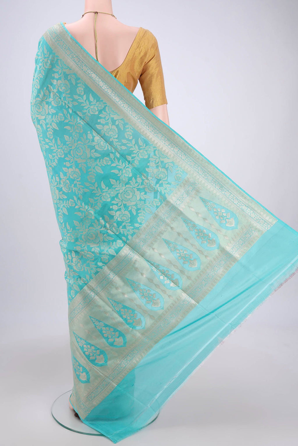 Flat view of Sky Blue Banarasi Silk Saree with Zari And Thread Butta on the body and Zari Border. 