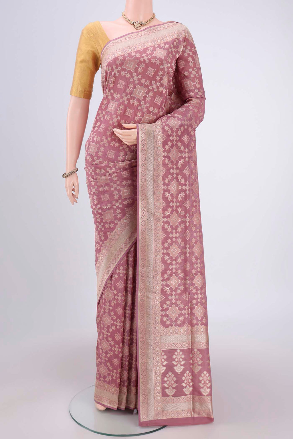 Mauve Banarasi Silk Saree with Zari And Thread Butta on the body and Zari Border.  displayed on a mannequin