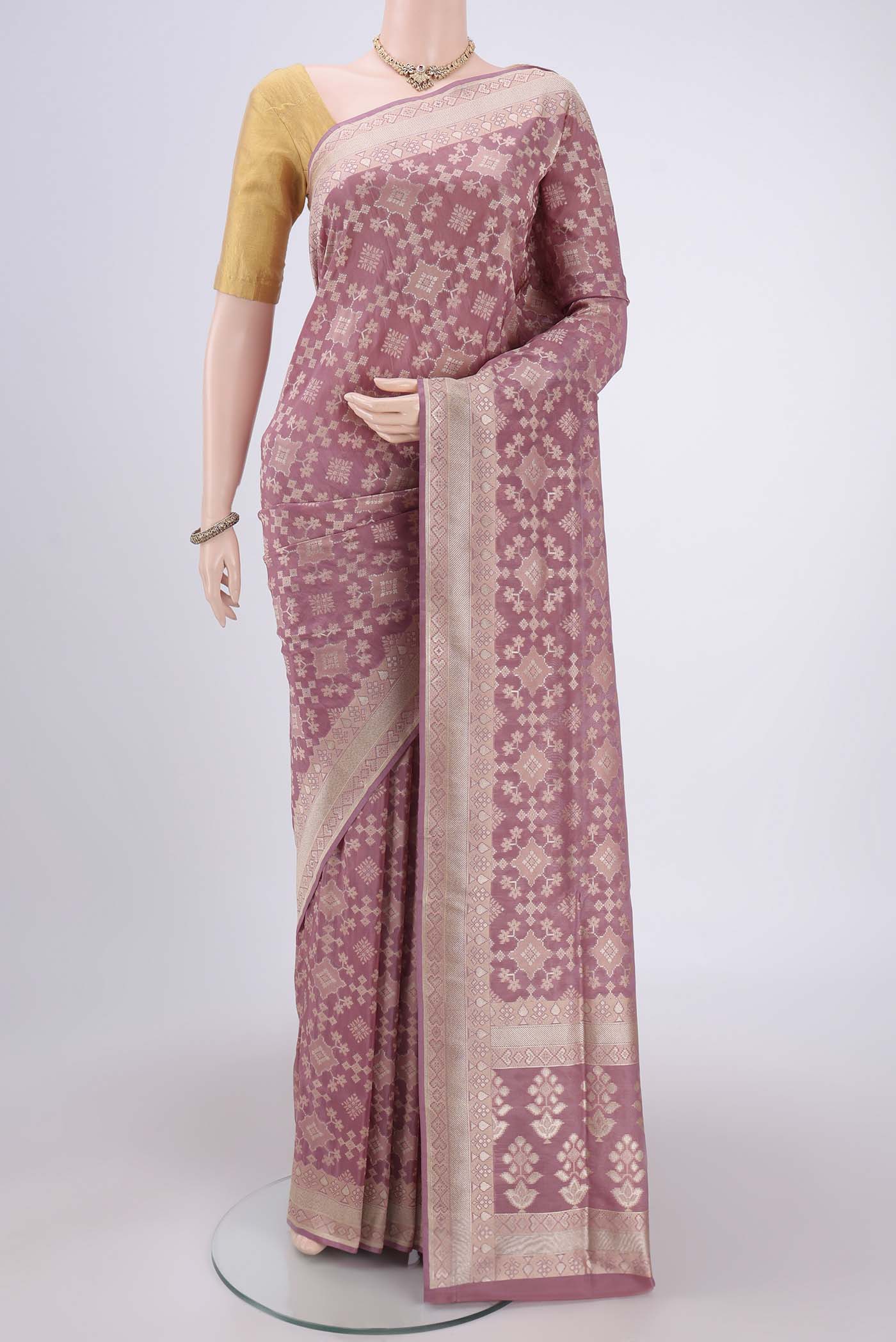 Mauve Banarasi Silk Saree with Zari And Thread Butta on the body and Zari Border.  displayed on a mannequin