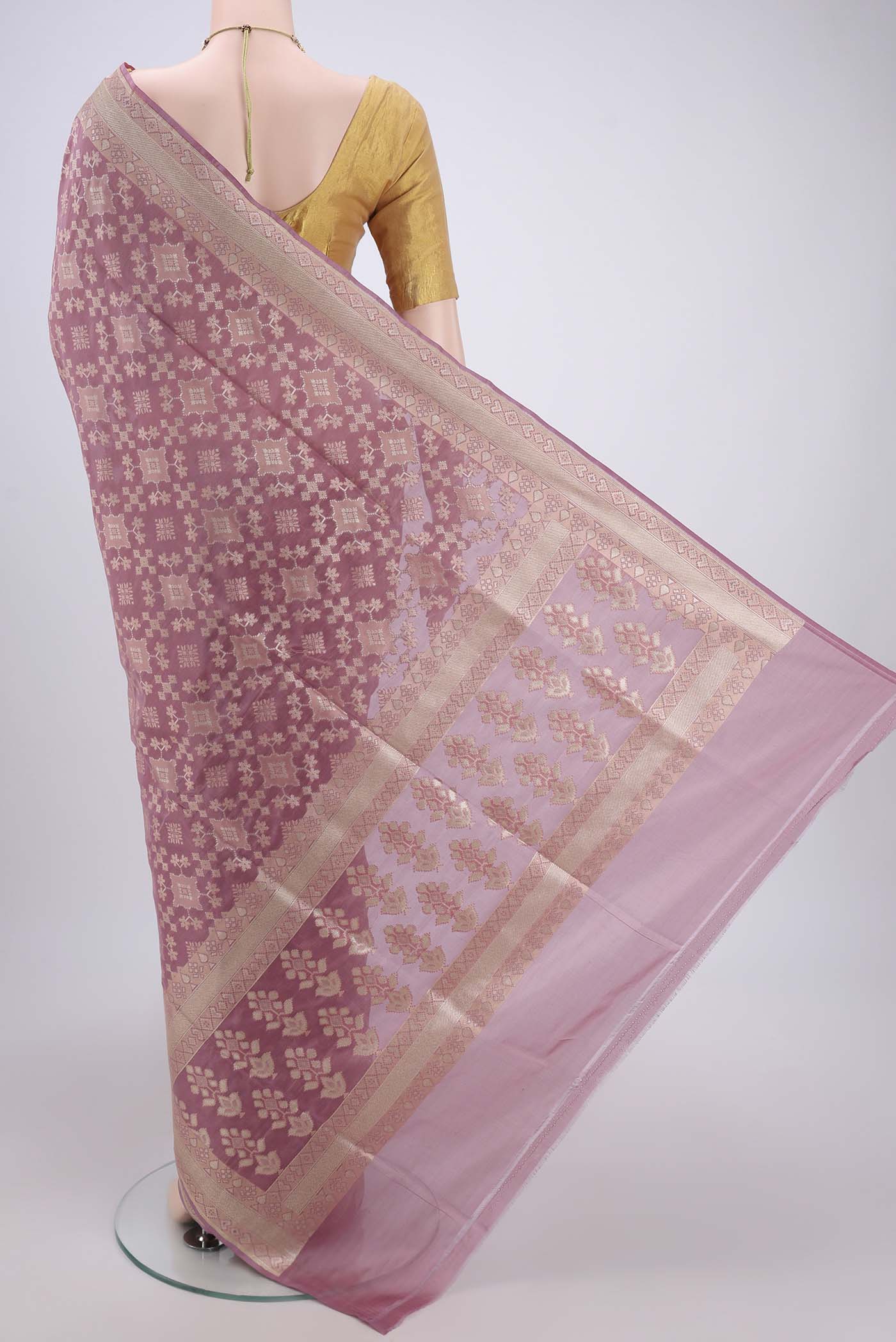 Flat view of Mauve Banarasi Silk Saree with Zari And Thread Butta on the body and Zari Border. 