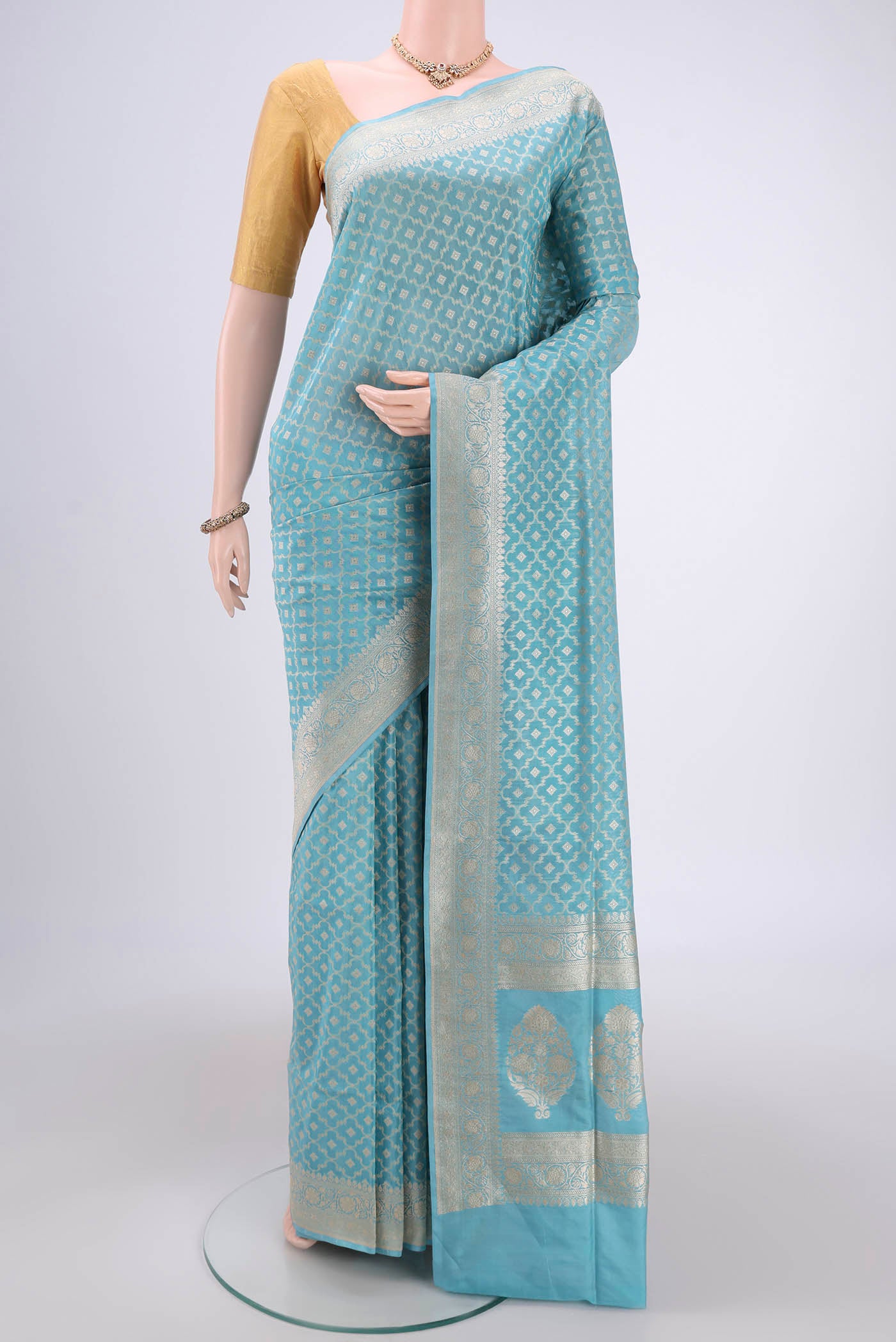 Sky Blue Banarasi Silk Saree with Zari And Thread Butta on the body and Zari Border.  displayed on a mannequin
