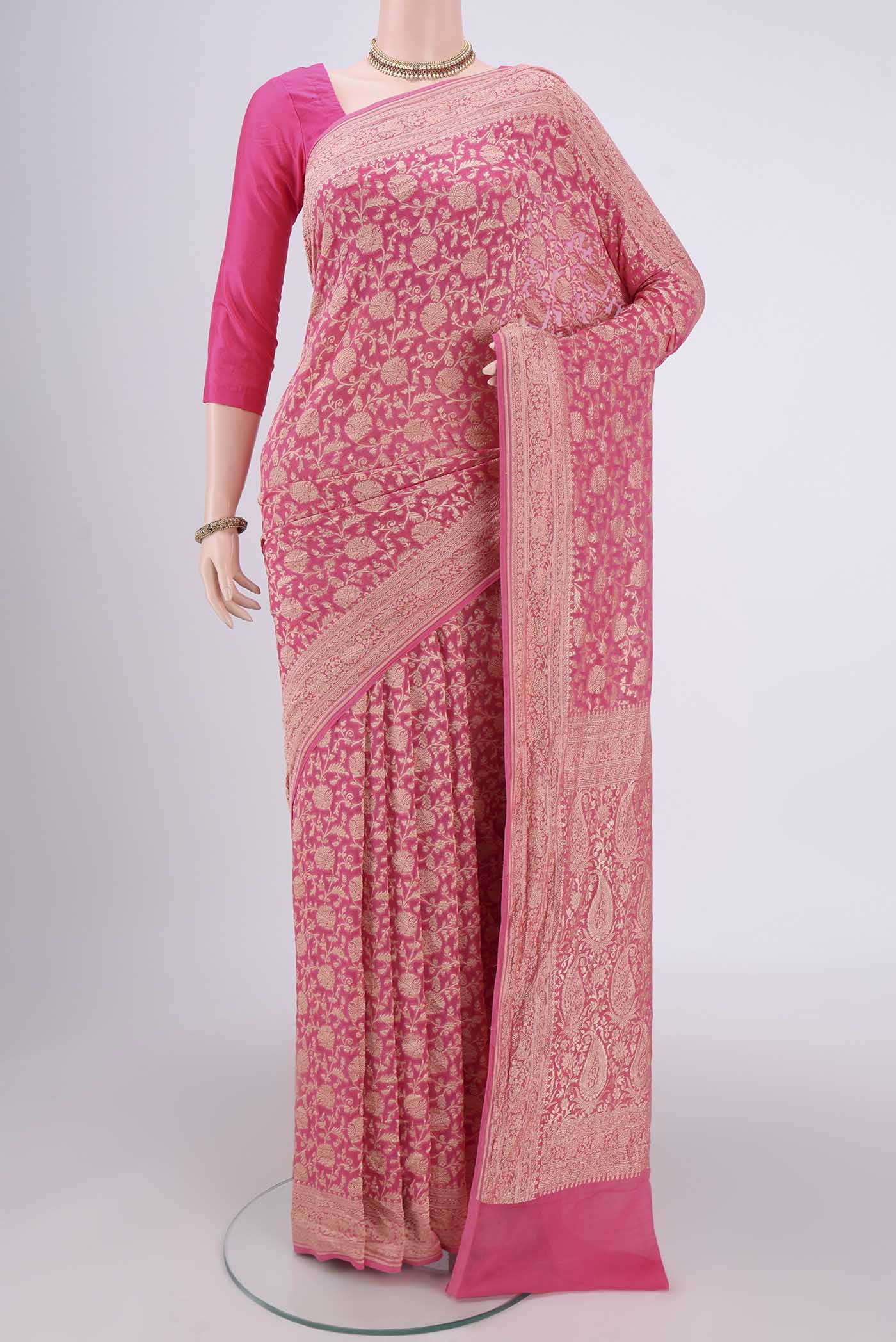 Pink Banarasi Georgette Saree with Zari Brocade on the body and Zari Border.  displayed on a mannequin
