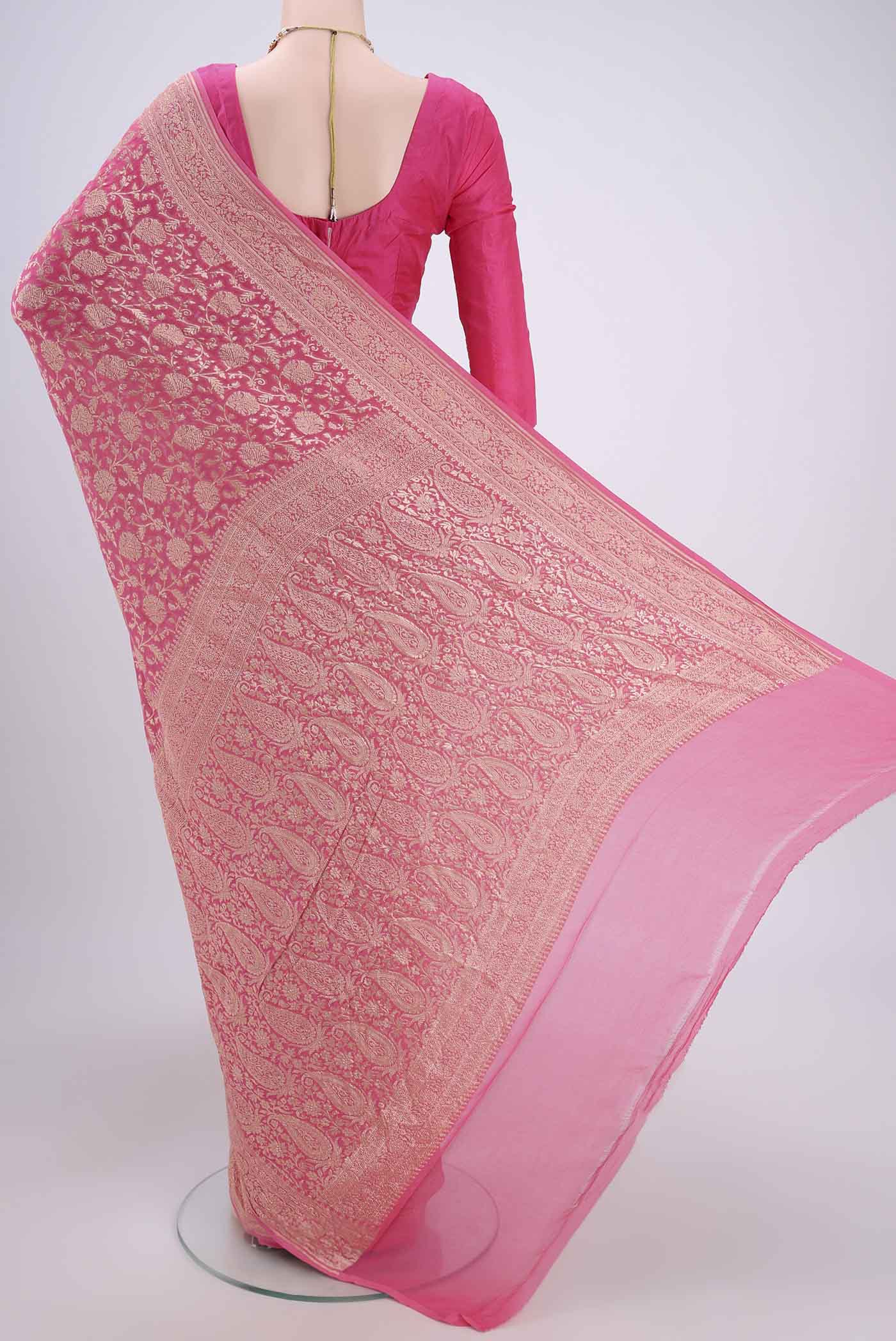 Flat view of Pink Banarasi Georgette Saree with Zari Brocade on the body and Zari Border. 