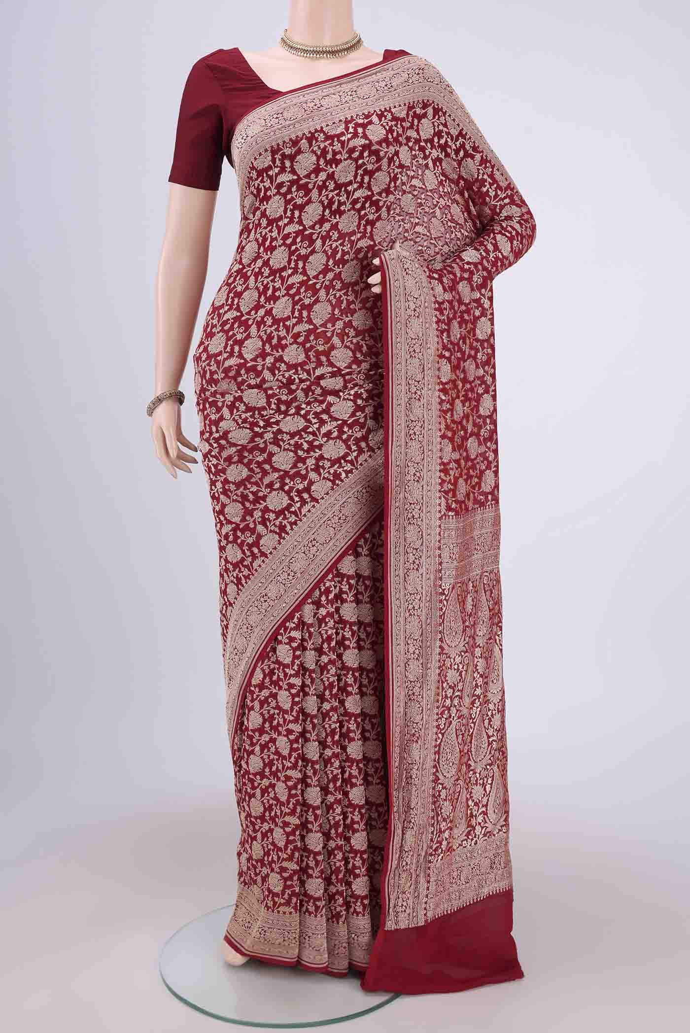 Maroon Banarasi Georgette Saree with Zari Brocade on the body and Zari Border.  displayed on a mannequin