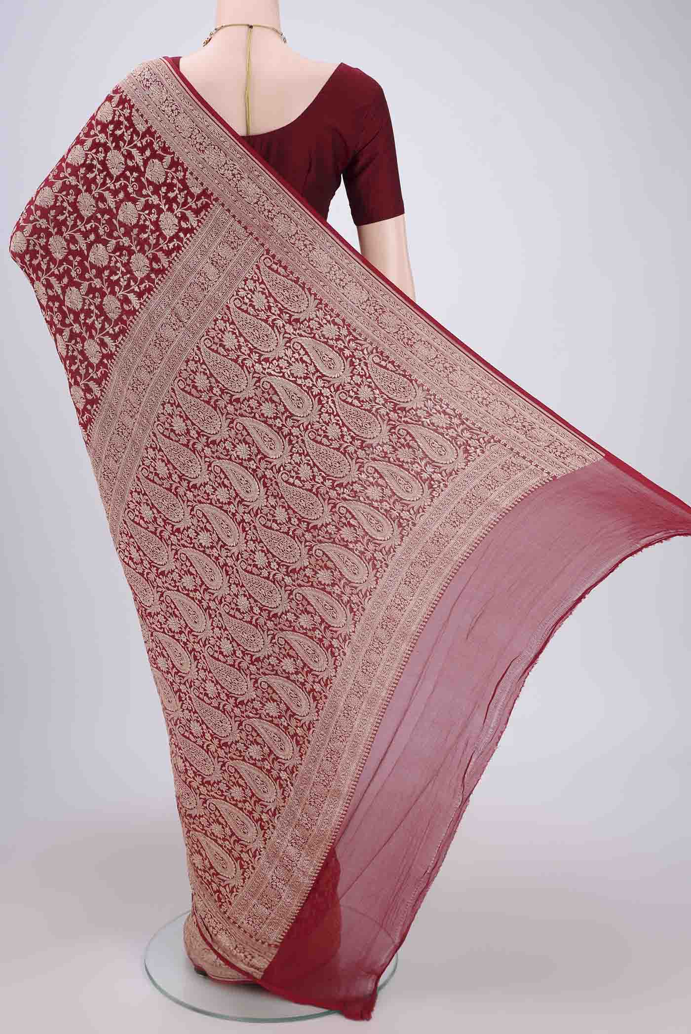 Flat view of Maroon Banarasi Georgette Saree with Zari Brocade on the body and Zari Border. 
