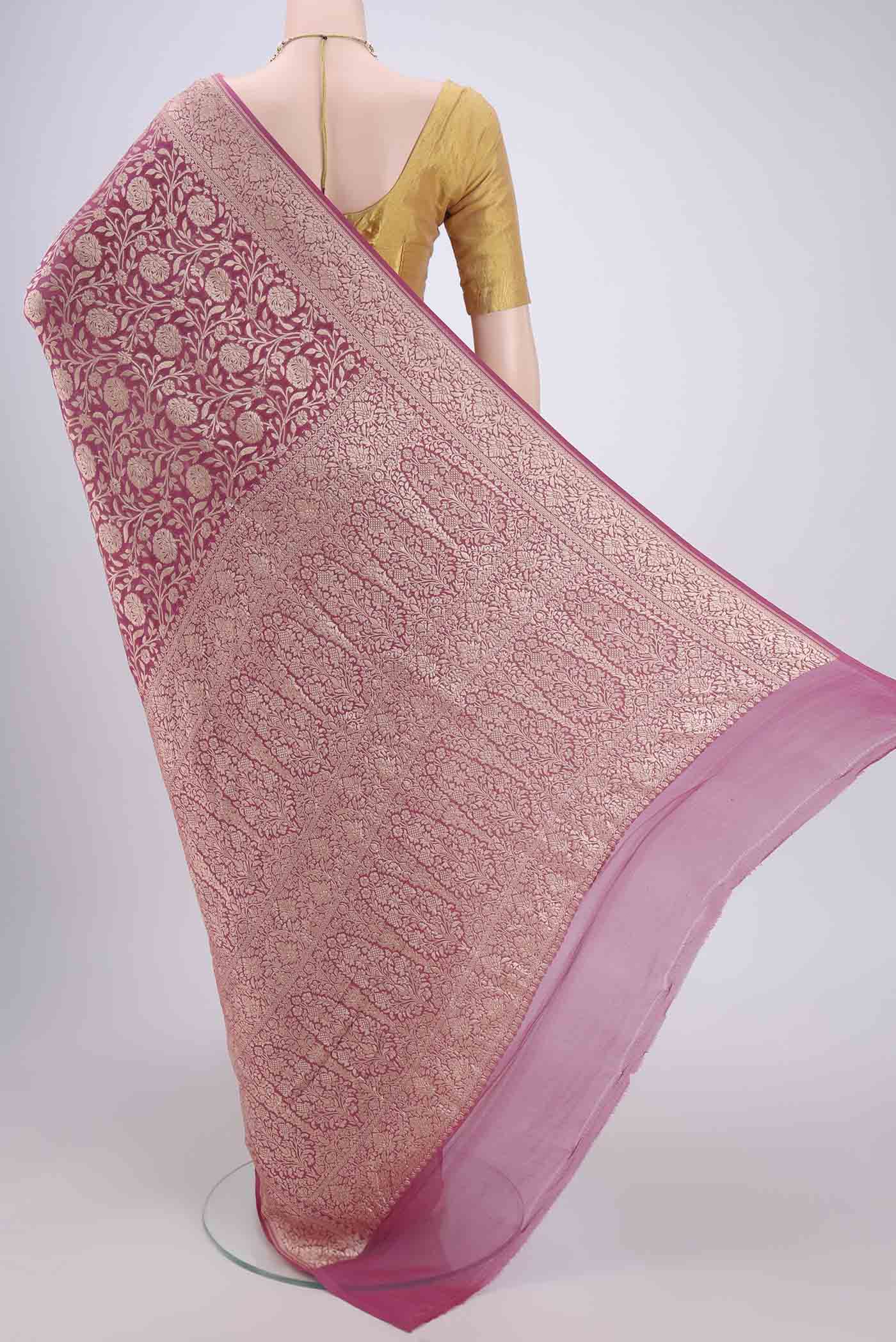 Flat view of Pink Banarasi Georgette Saree with Zari Brocade on the body and Zari Border. 