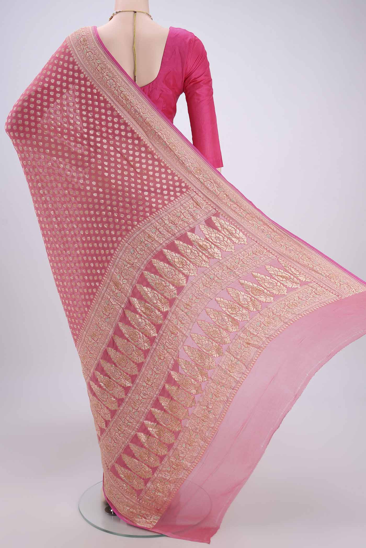 Flat view of Pink Banarasi Georgette Saree with Zari Butta on the body and Zari Border. 