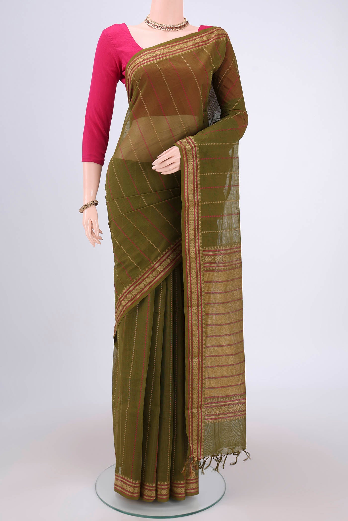 Olive Green Kanchi Cotton Saree with Stripes on the body and Thread Border.  displayed on a mannequin