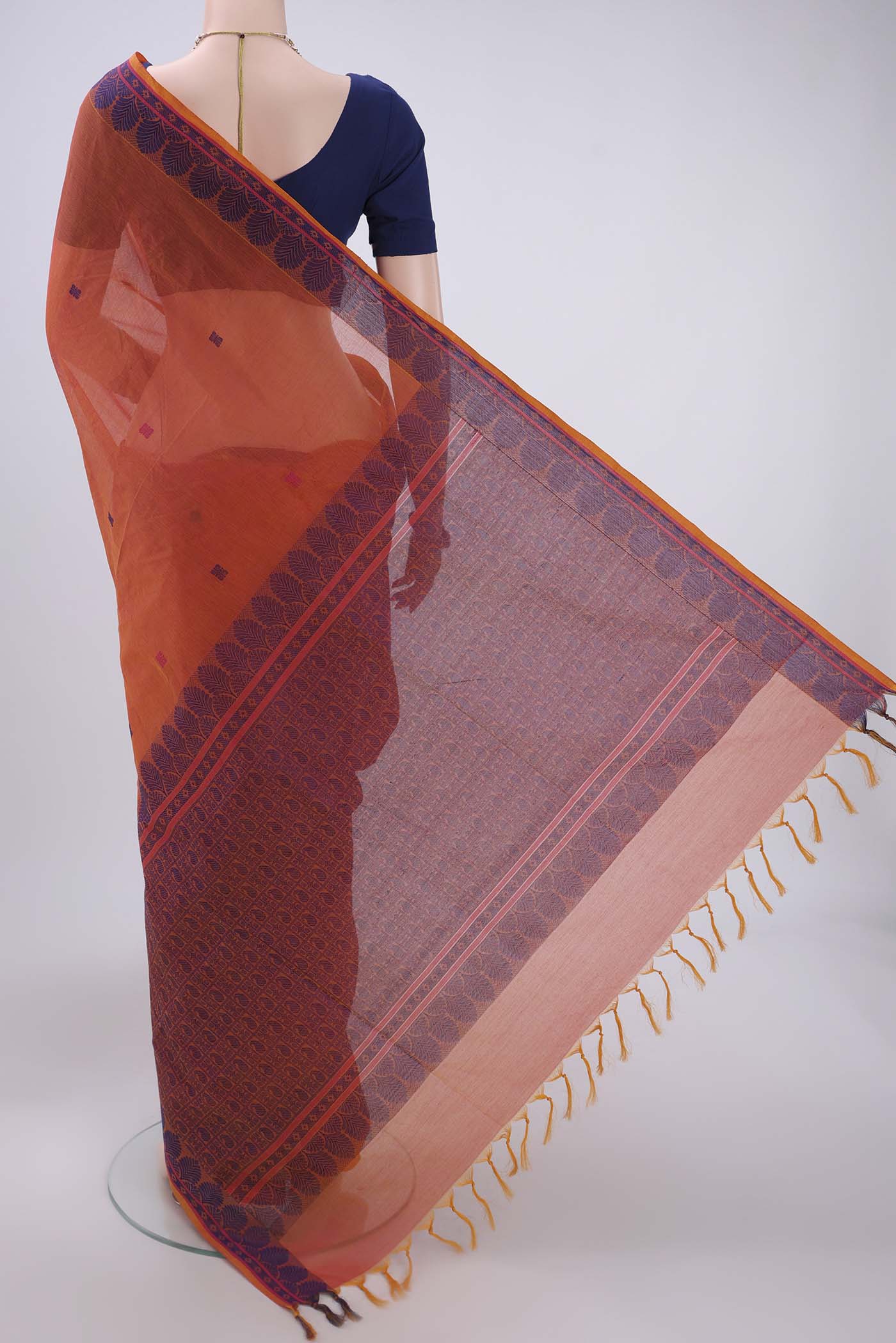 Flat view of Orange Coimbatore Cotton Saree with Thread Butta on the body and Thread Border. 