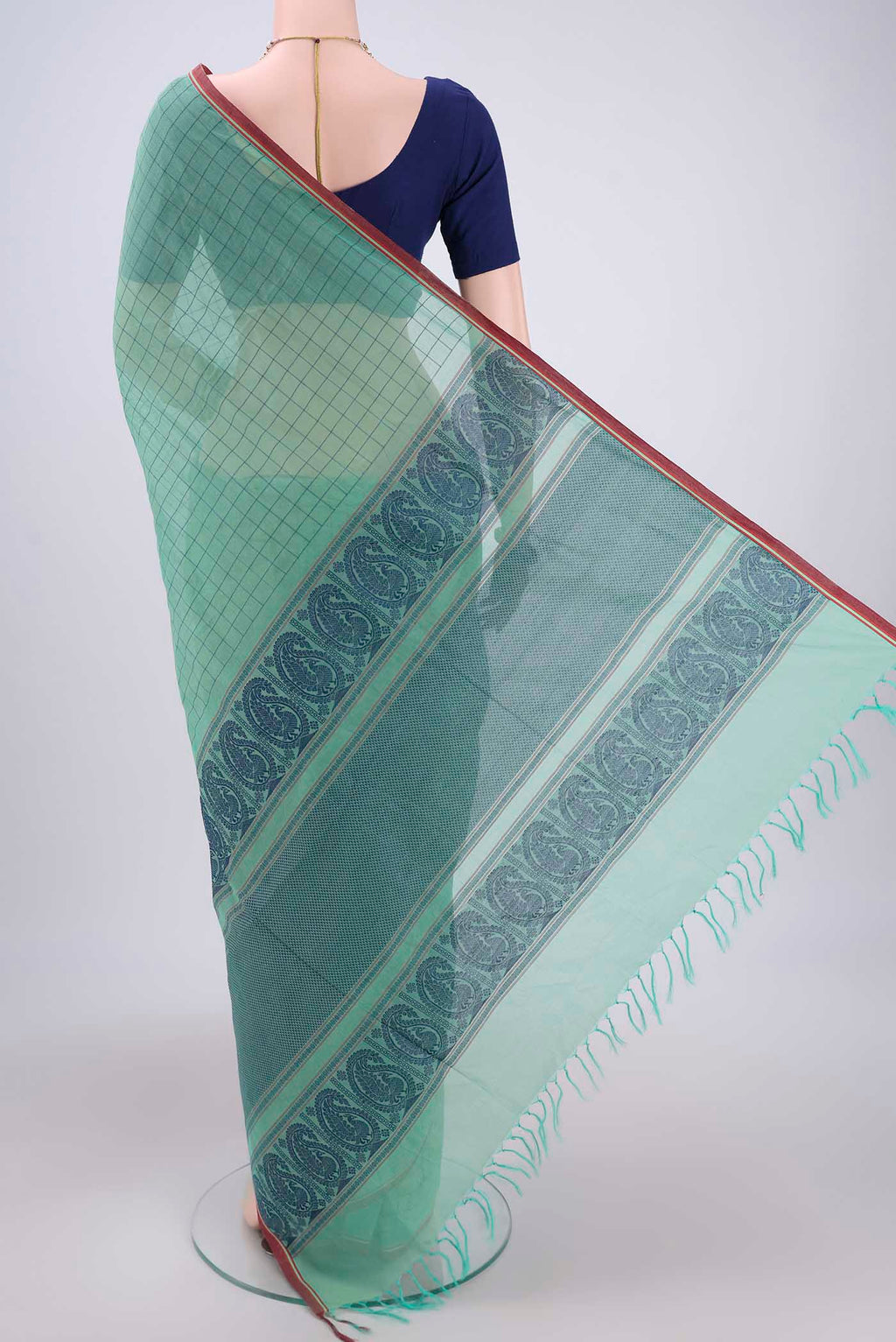 Flat view of Mint Green Coimbatore Cotton Saree with Thread Butta on the body and Thread Border. 