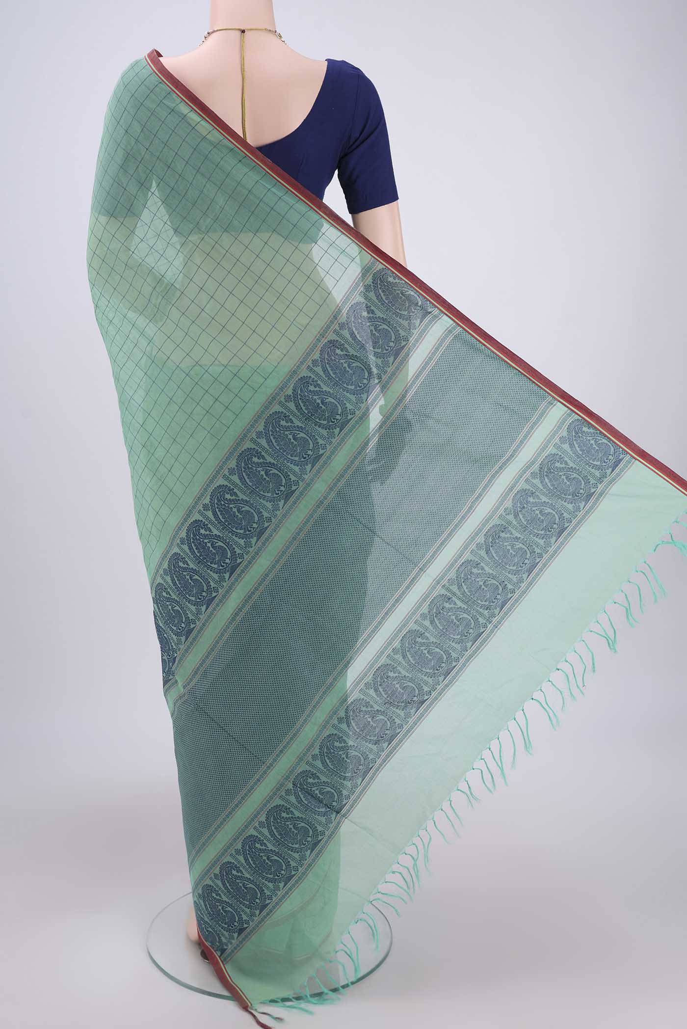 Flat view of Mint Green Coimbatore Cotton Saree with Thread Butta on the body and Thread Border. 