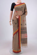 Brown Coimbatore Cotton Saree with Thread Butta on the body and Thread Border.  displayed on a mannequin
