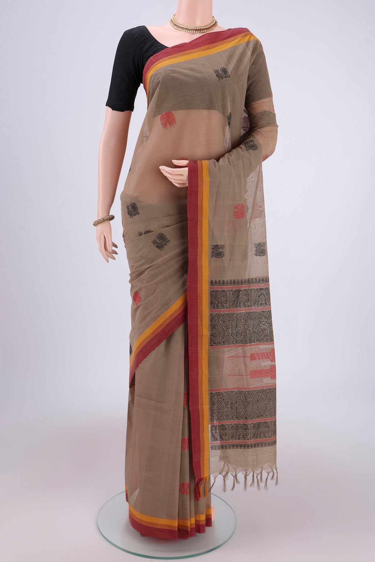 Brown Coimbatore Cotton Saree with Thread Butta on the body and Thread Border.  displayed on a mannequin