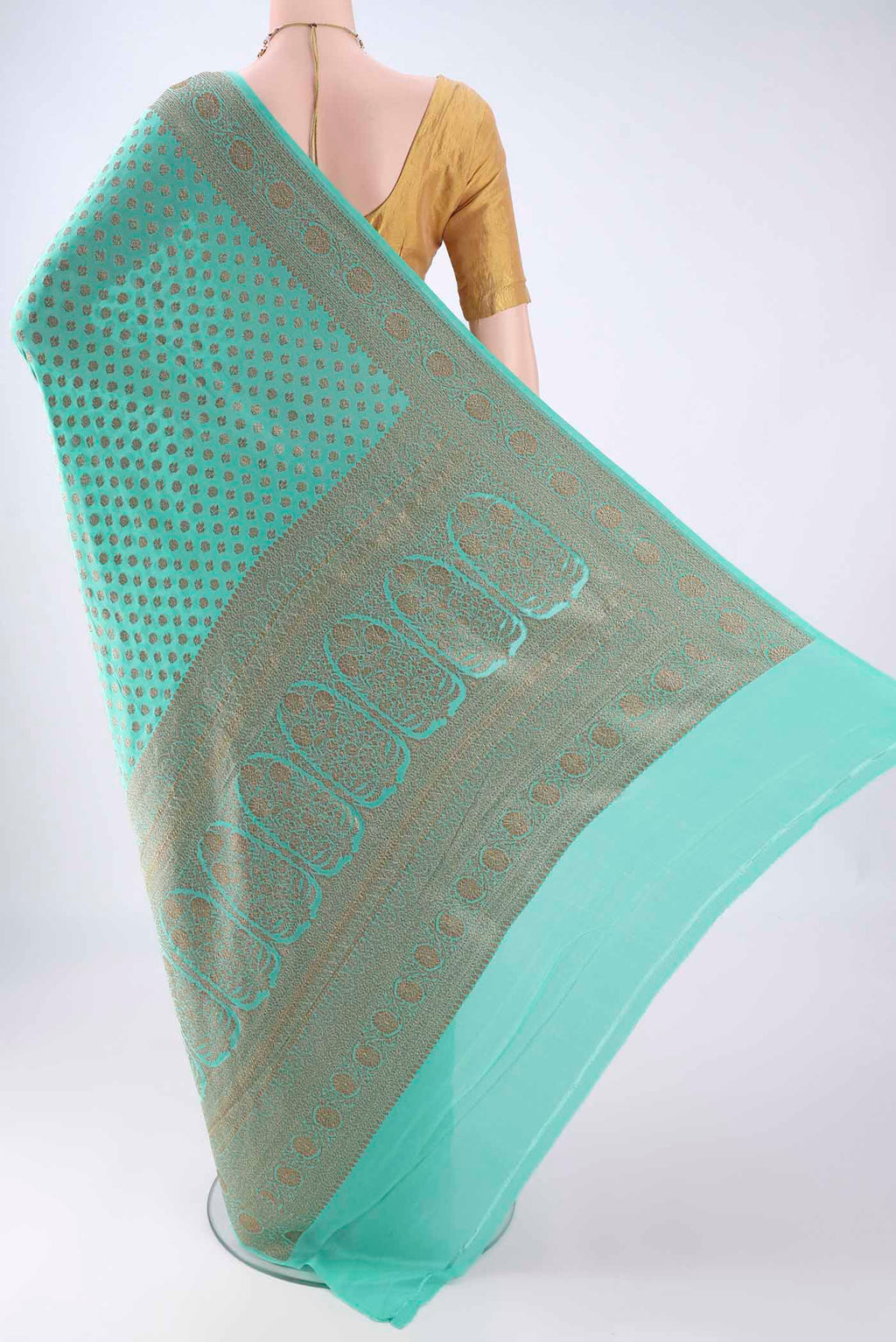 Flat view of Turquoise Banarasi Georgette Saree with Zari Butta on the body and Zari Border. 