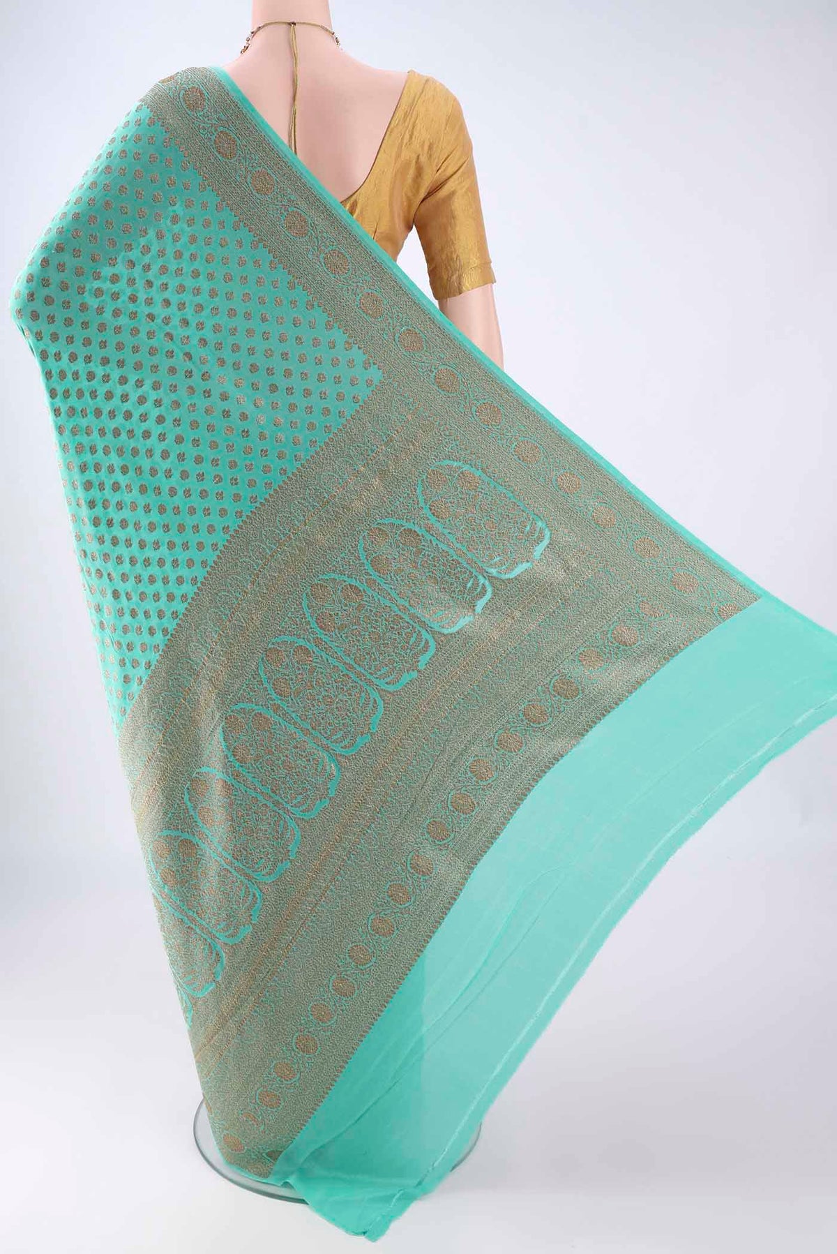 Flat view of Turquoise Banarasi Georgette Saree with Zari Butta on the body and Zari Border. 