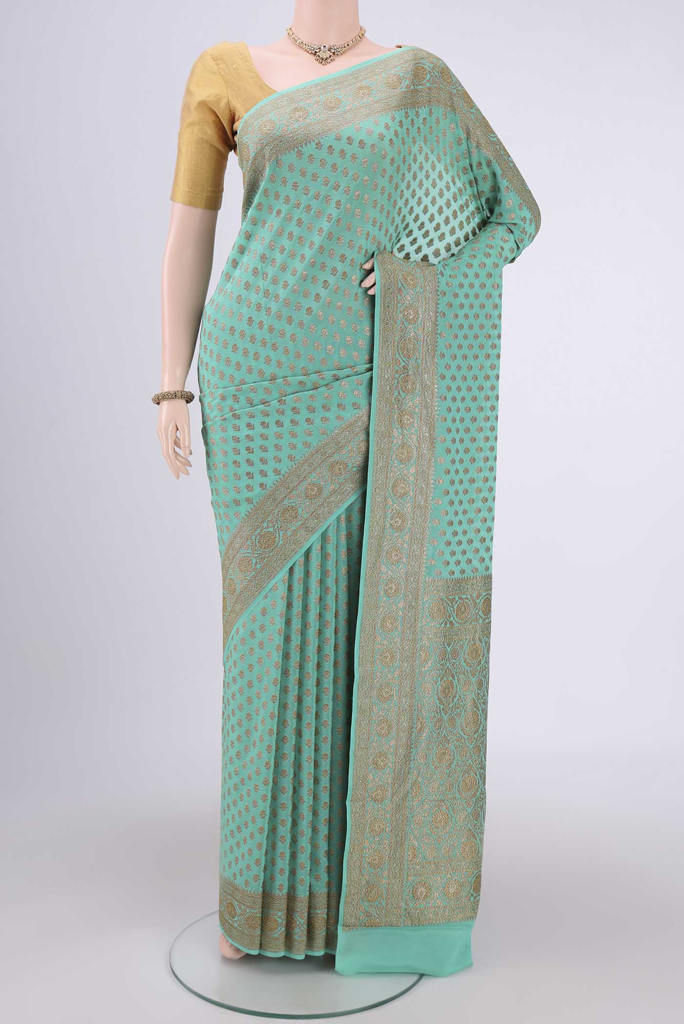 Sea Green Banarasi Georgette Saree with Zari Brocade on the body and Zari Border.  displayed on a mannequin