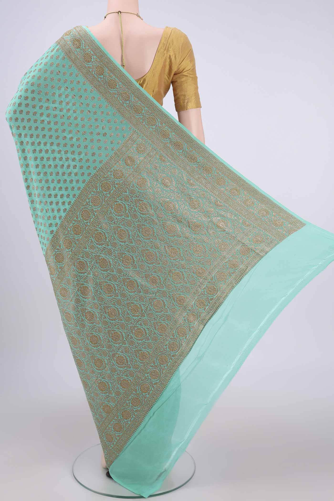 Flat view of Sea Green Banarasi Georgette Saree with Zari Brocade on the body and Zari Border. 