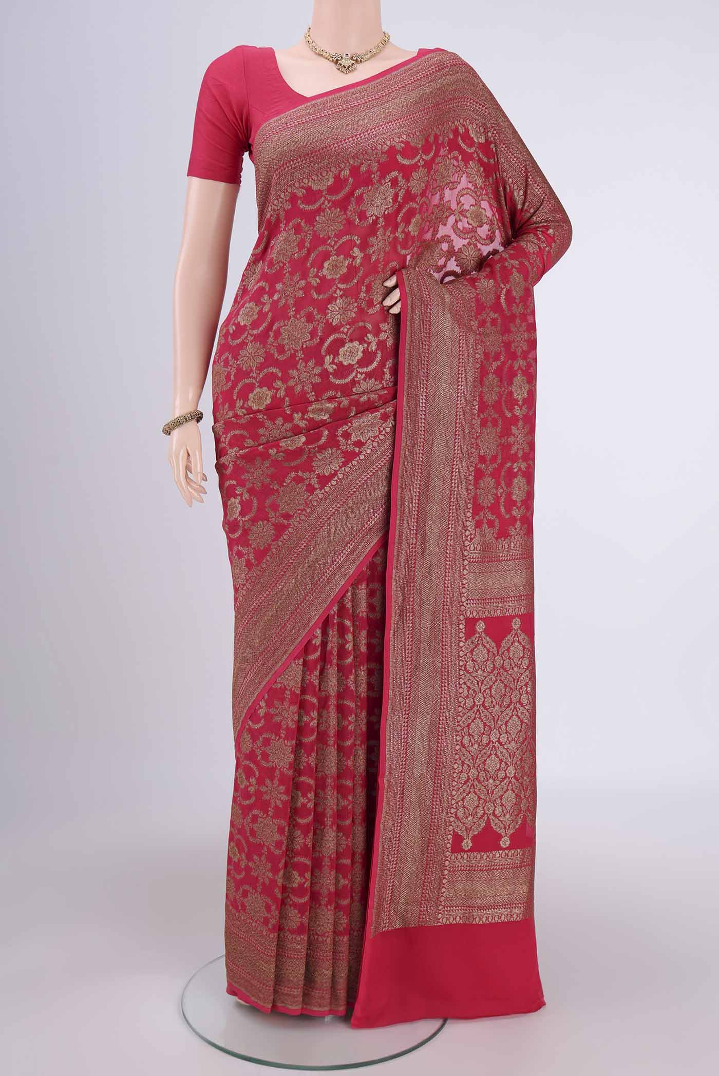 Dark Pink Banarasi Georgette Saree with Zari Brocade on the body and Zari Border.  displayed on a mannequin