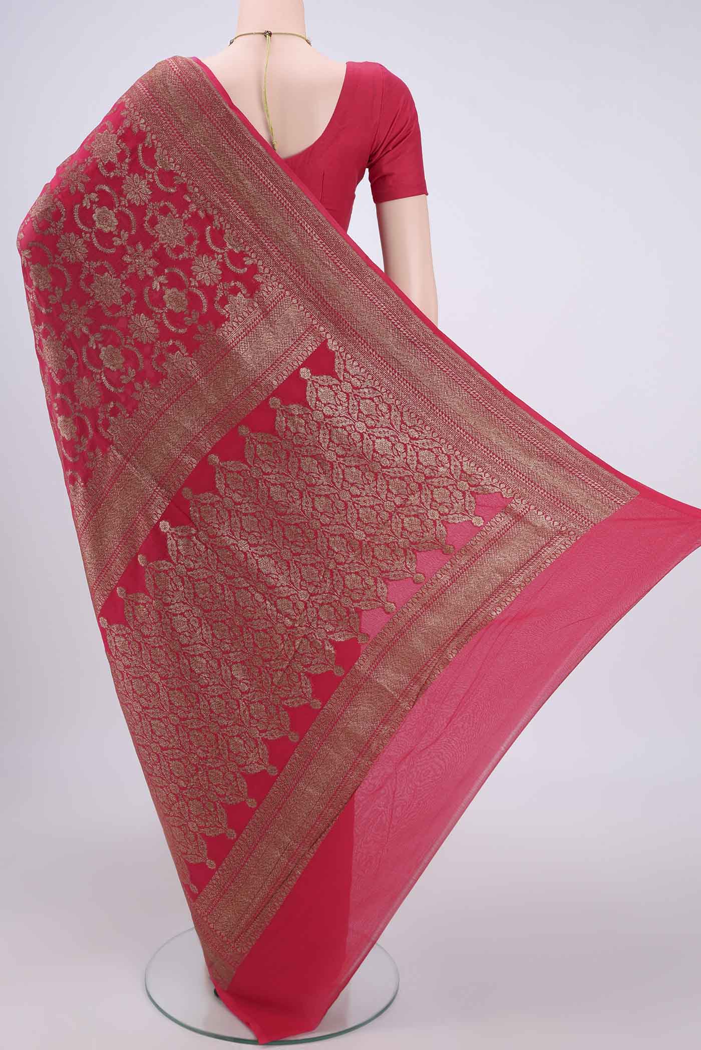 Flat view of Dark Pink Banarasi Georgette Saree with Zari Brocade on the body and Zari Border. 