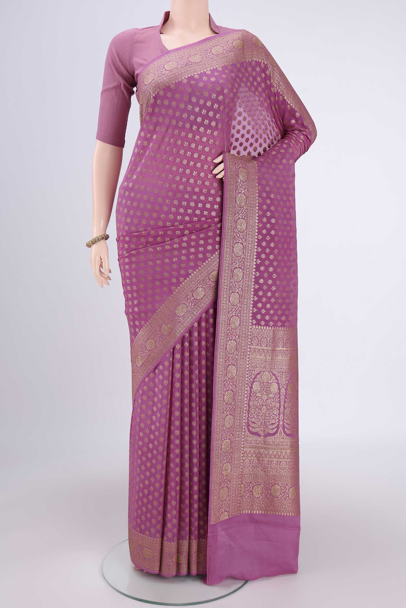 Rose pink Banarasi Georgette Saree with Zari Butta on the body and Zari Border.  displayed on a mannequin