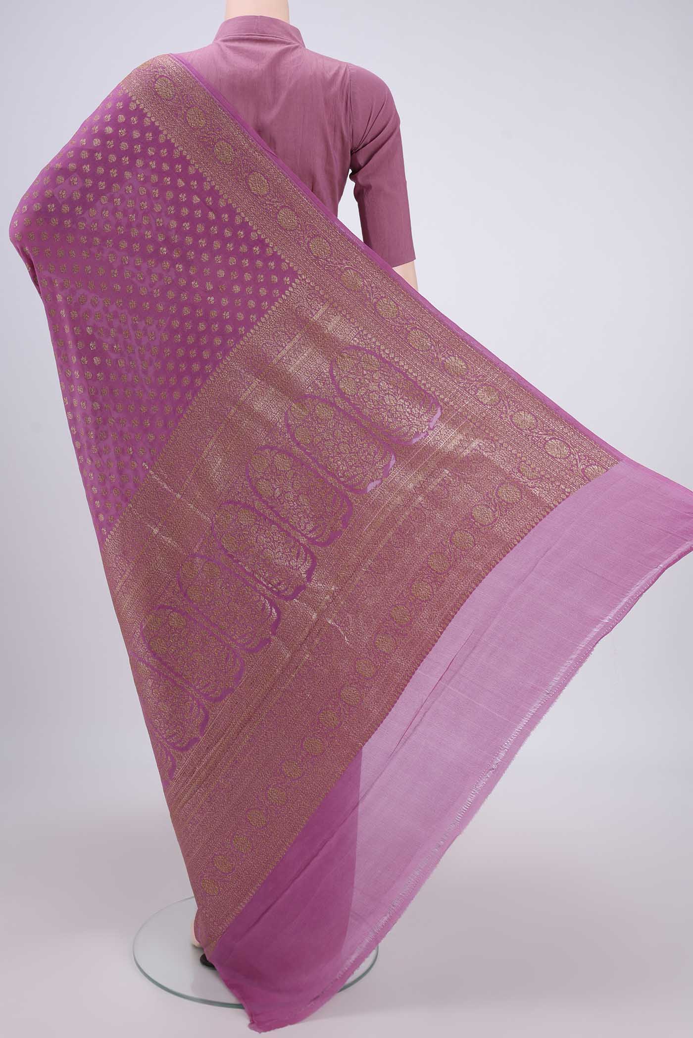 Flat view of Rose pink Banarasi Georgette Saree with Zari Butta on the body and Zari Border. 