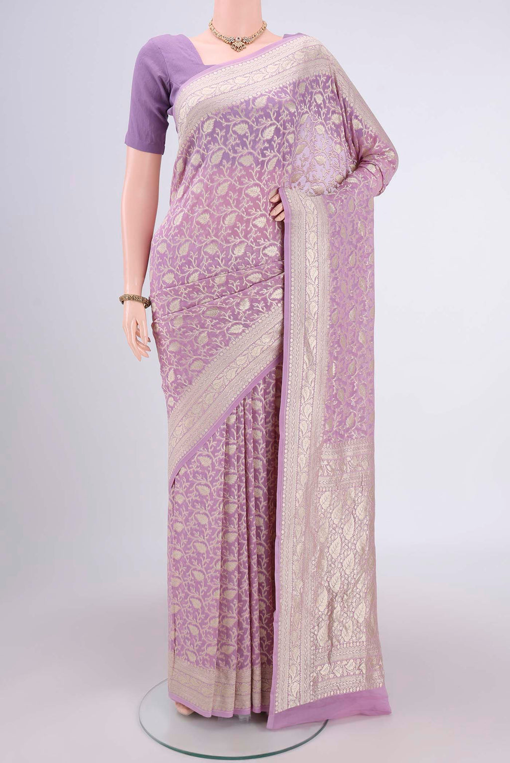 Lavender Banarasi Georgette Saree with Zari Brocade on the body and Zari Border.  displayed on a mannequin