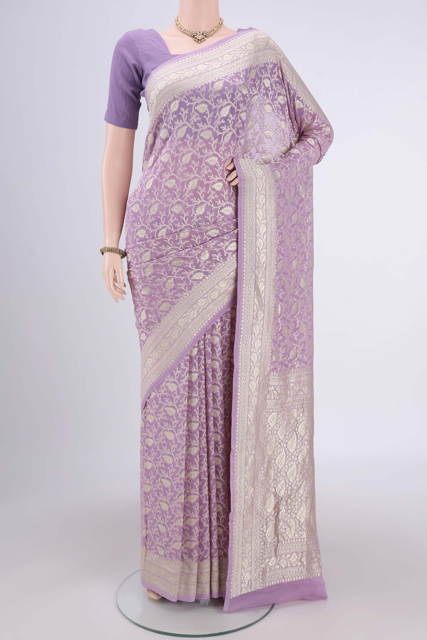 Lavender Banarasi Georgette Saree with Zari Brocade on the body and Zari Border.  displayed on a mannequin
