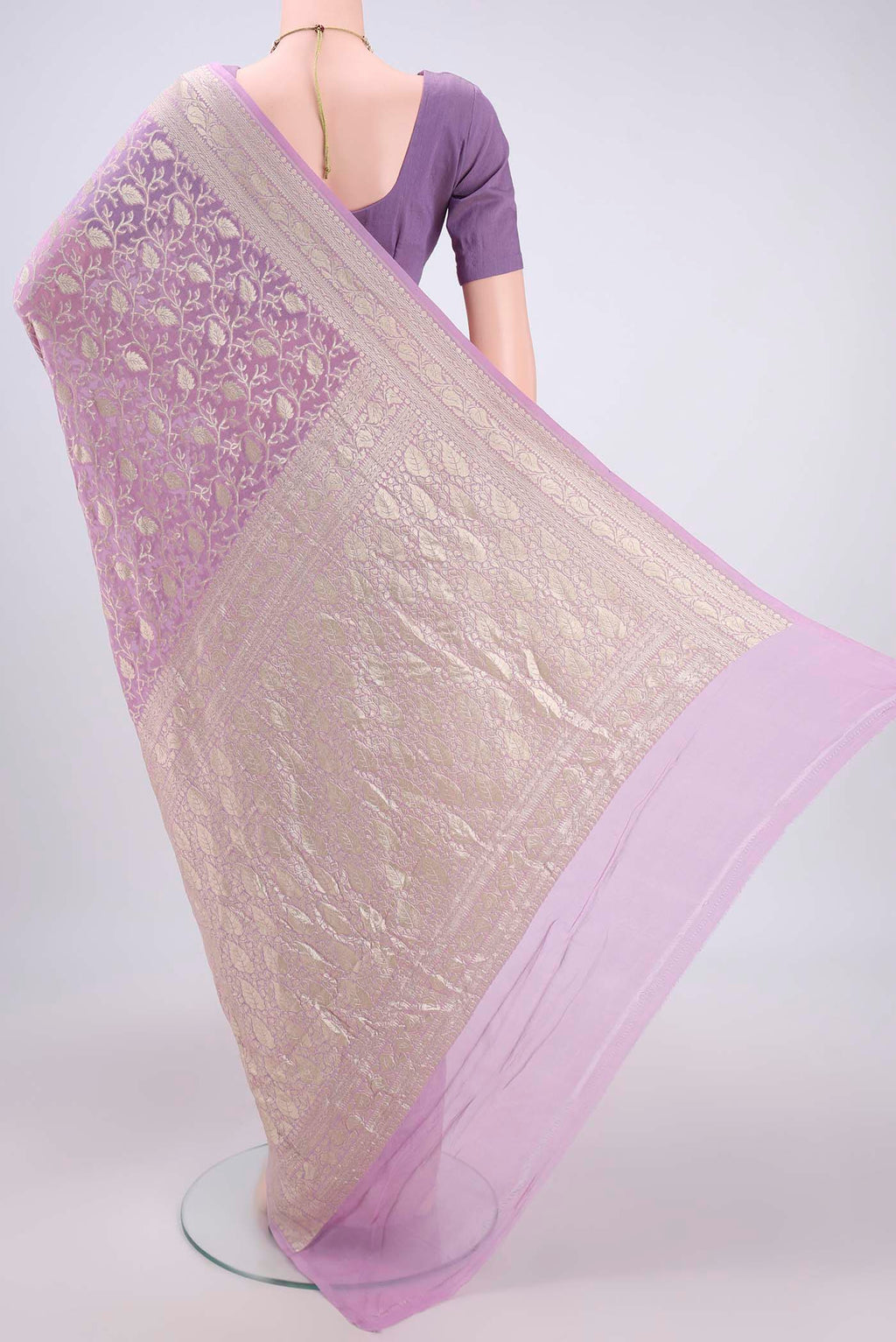 Flat view of Lavender Banarasi Georgette Saree with Zari Brocade on the body and Zari Border. 