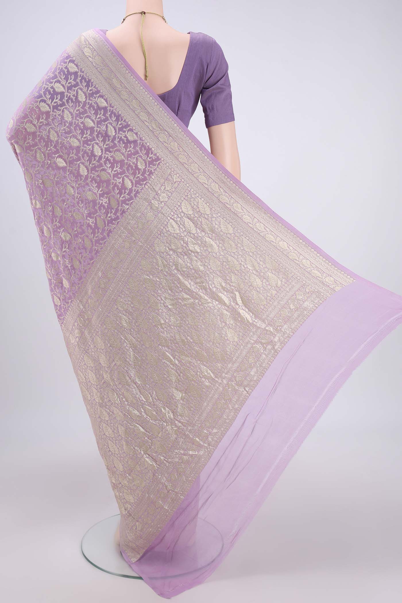 Flat view of Lavender Banarasi Georgette Saree with Zari Brocade on the body and Zari Border. 