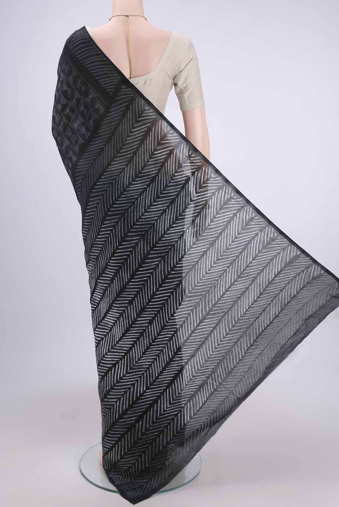 Flat view of Black Chanderi Silk Saree with Printed design on the body and Zari Border. 