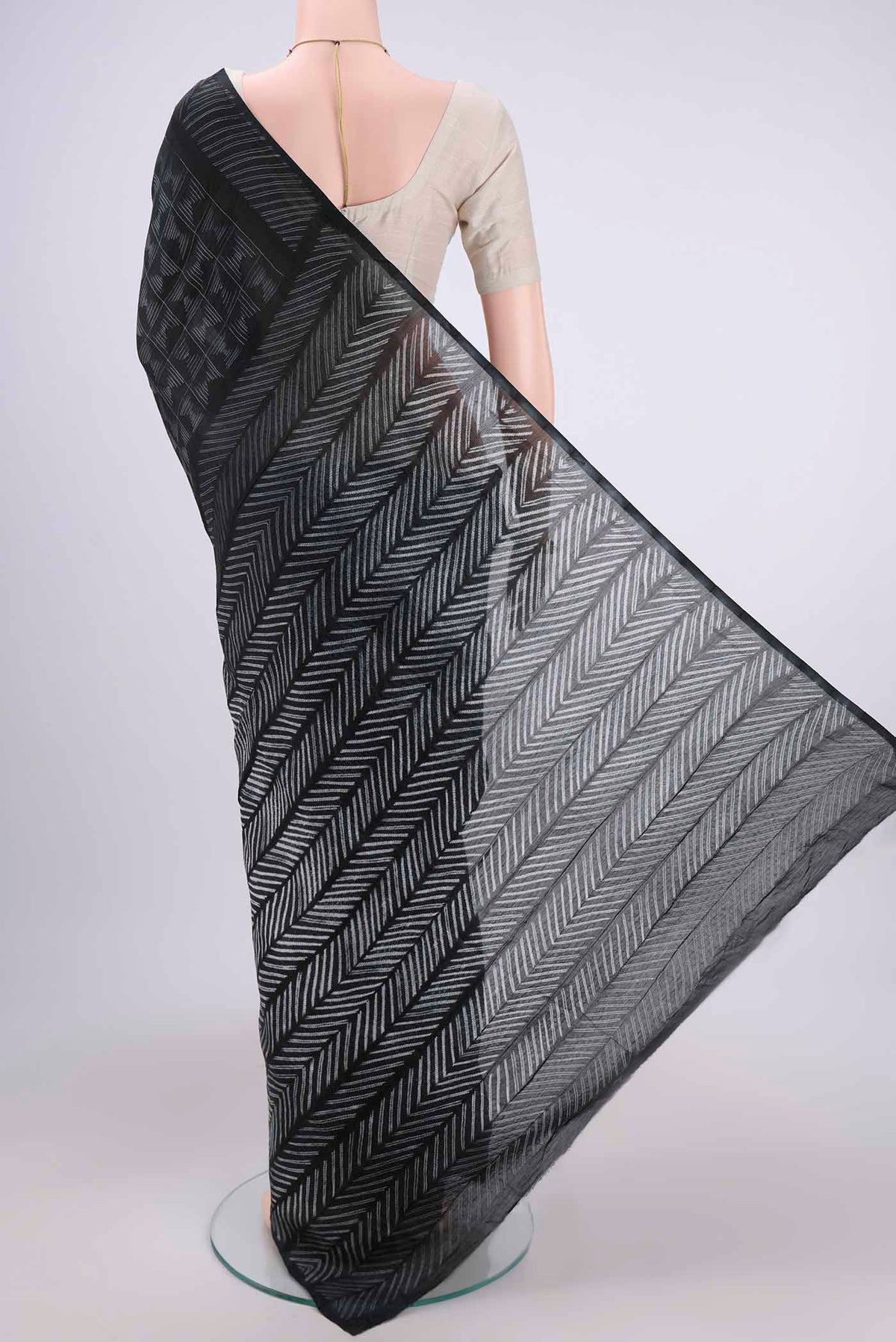 Flat view of Black Chanderi Silk Saree with Printed design on the body and Zari Border. 