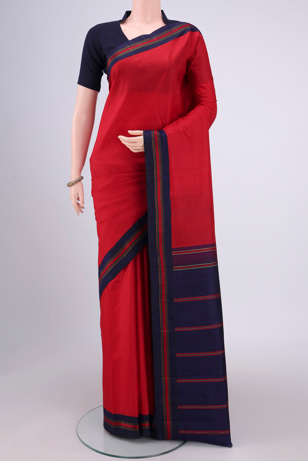 Red Dual Tone Kanjivaram Silk Saree with Plain Body and Thread Border.  displayed on a mannequin