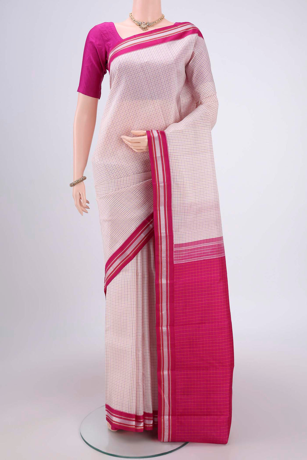 Off White Dual Tone Kanjivaram Silk Saree with Checked design on the body and Thread Border.  displayed on a mannequin