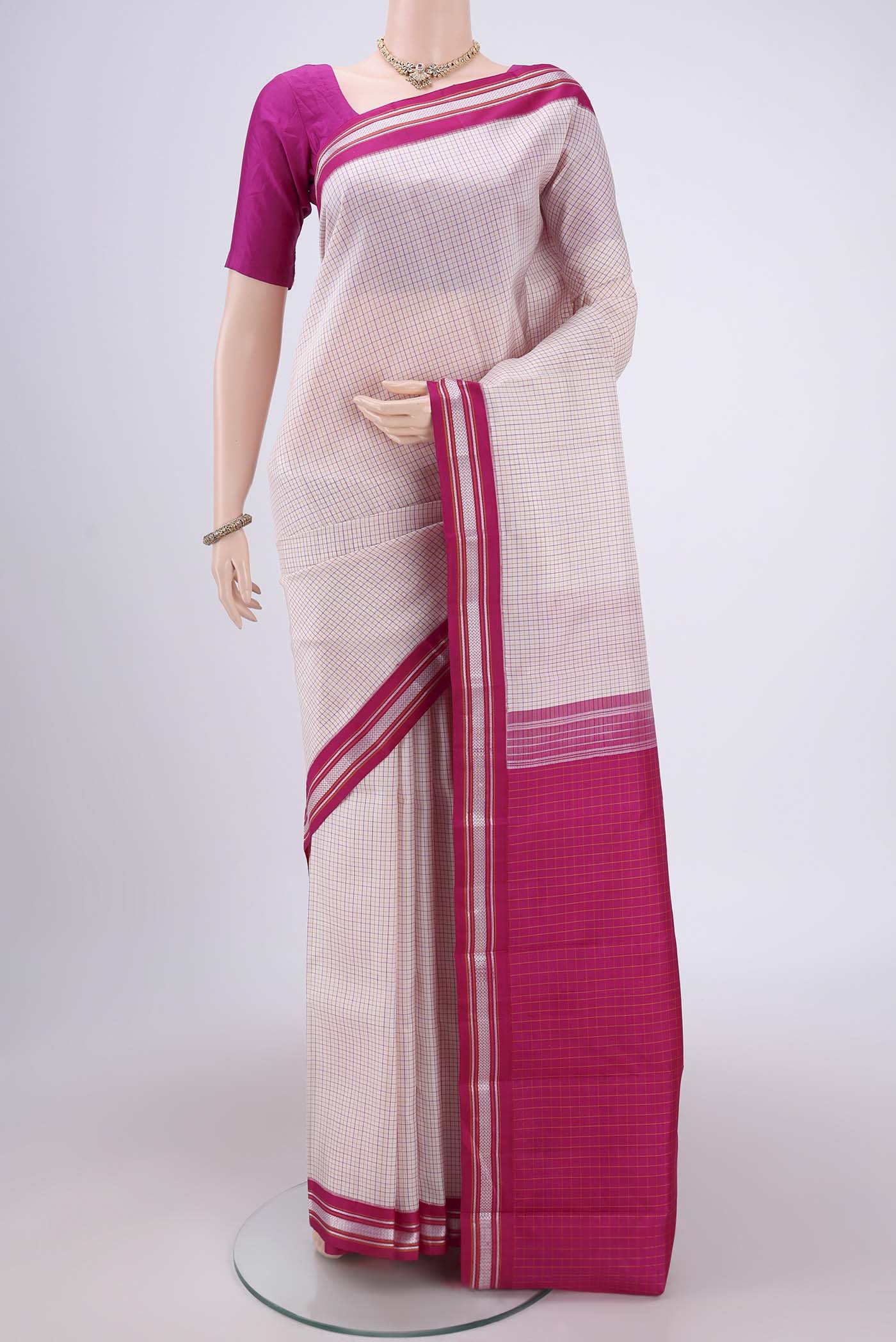 Off White Dual Tone Kanjivaram Silk Saree with Checked design on the body and Thread Border.  displayed on a mannequin