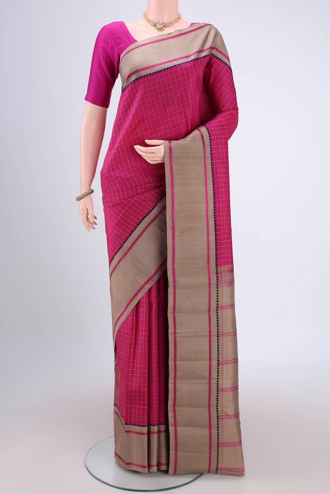 Rani Pink Dual Tone Kanjivaram Silk Saree with Checked design on the body and Zari Border.  displayed on a mannequin
