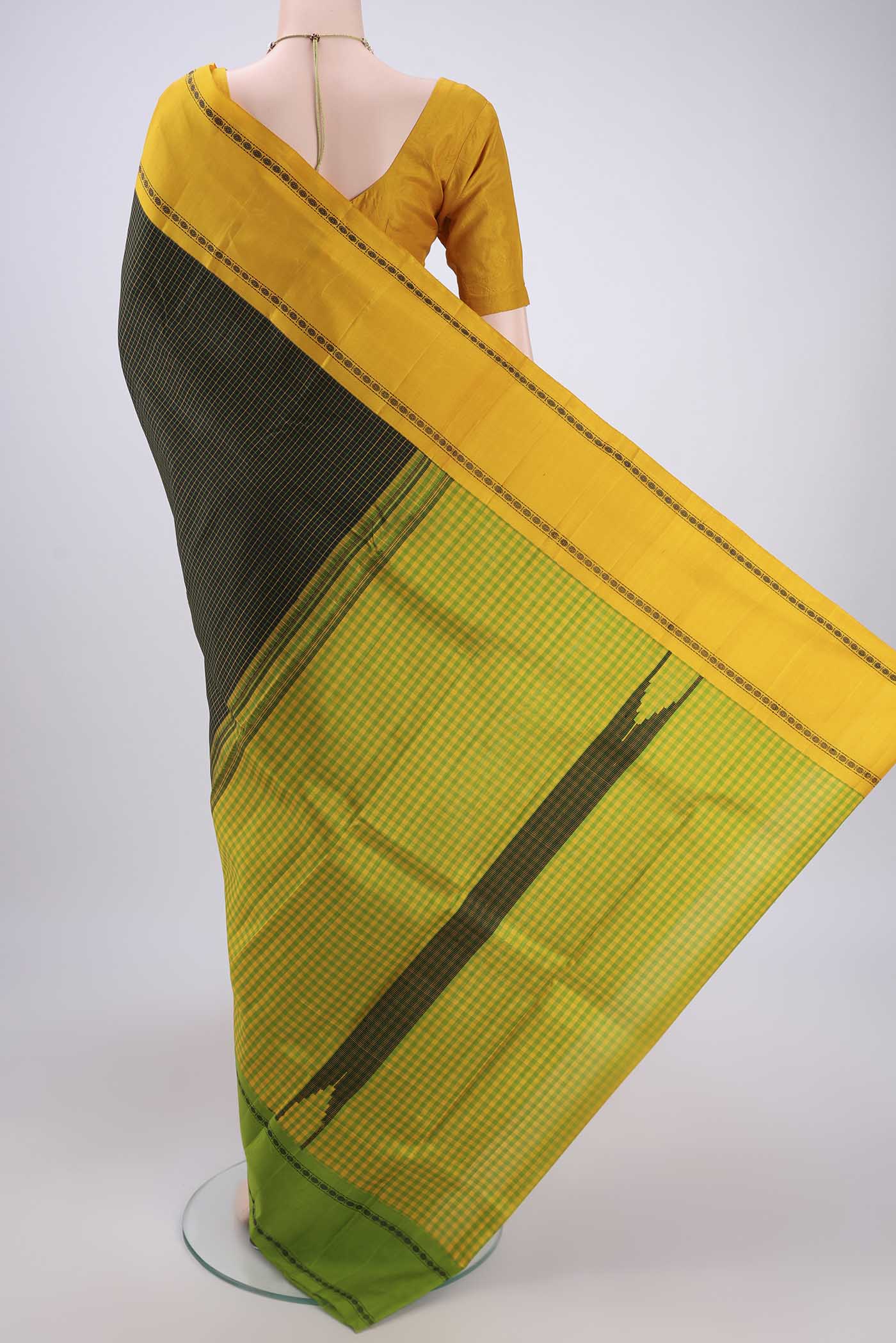 Flat view of Black Dual Tone Kanchipuram Silk Saree with Checked design on the body and Ganga Jamuna Border. 