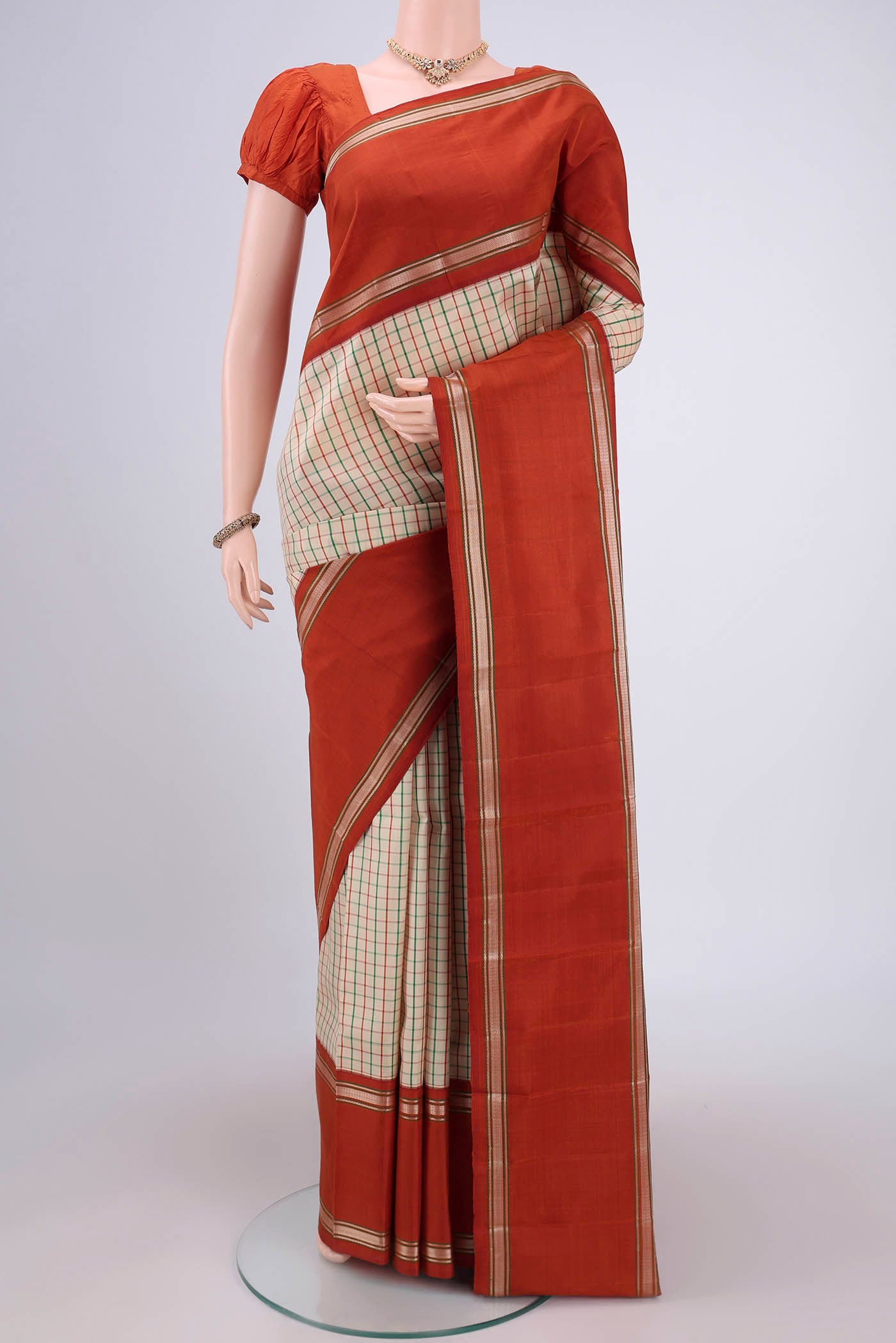 Cream Dual Tone Kanjivaram Silk Saree with Checked design on the body and Zari Border.  displayed on a mannequin