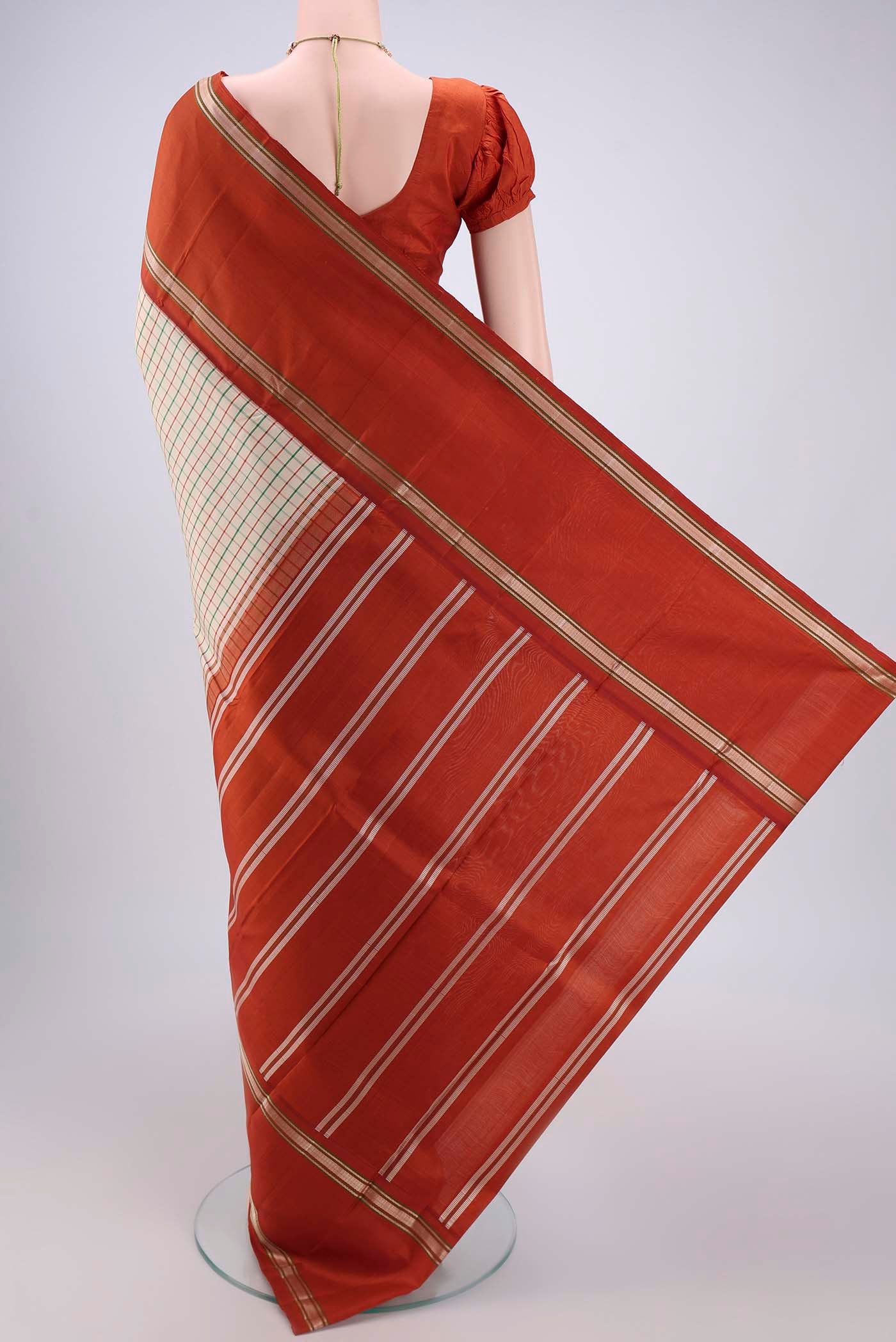 Flat view of Cream Dual Tone Kanjivaram Silk Saree with Checked design on the body and Zari Border. 