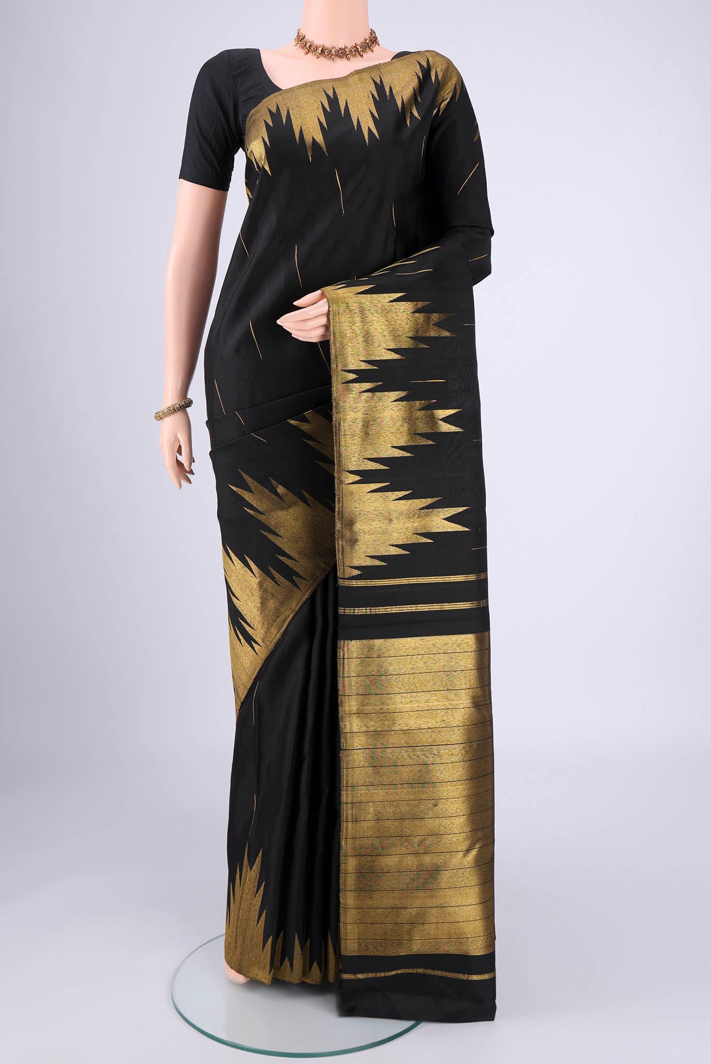 Black Dual Tone Kanjivaram Silk Saree with Plain Body and Temple Border.  displayed on a mannequin