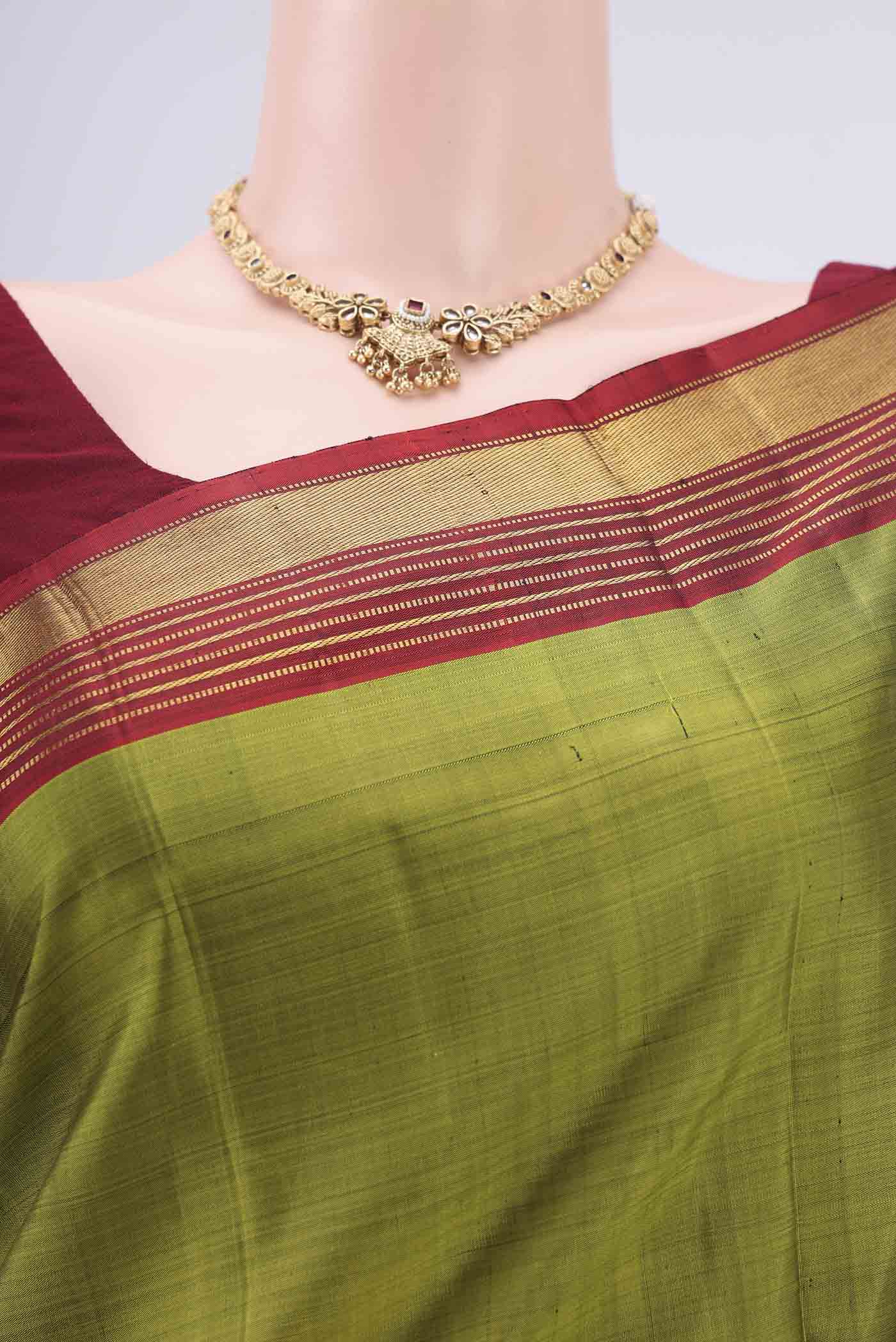Border image of Mehandi Green Kanjivaram Silk Saree with Plain Body and Zari Border. 