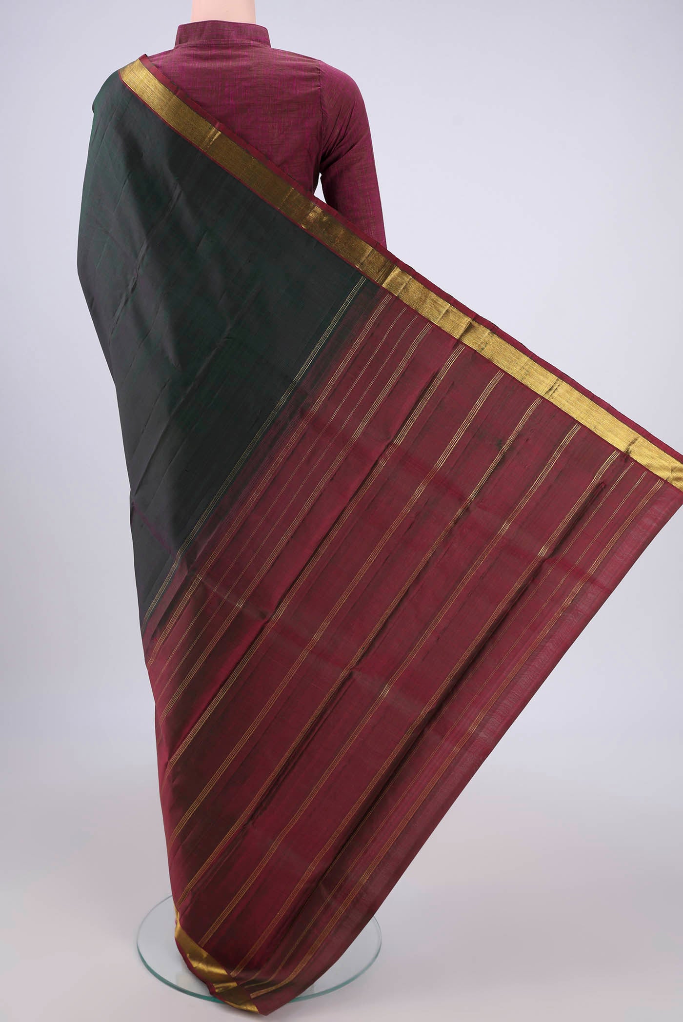 Flat view of Bottle Green Kanjivaram Silk Saree with Plain Body and Zari Border. 