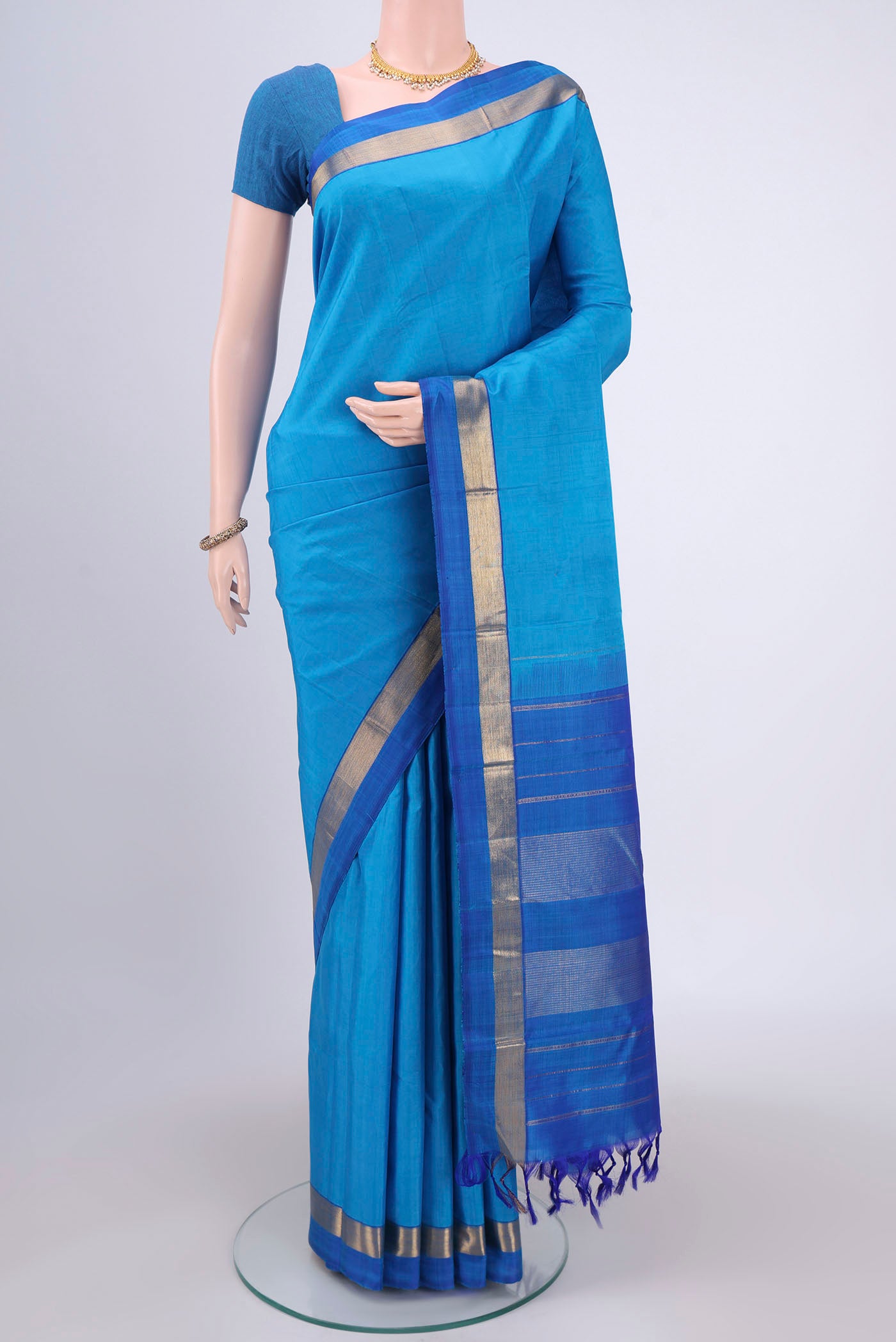 Blue Dual Tone Kanjivaram Silk Saree with Plain Body and Zari Border.  displayed on a mannequin