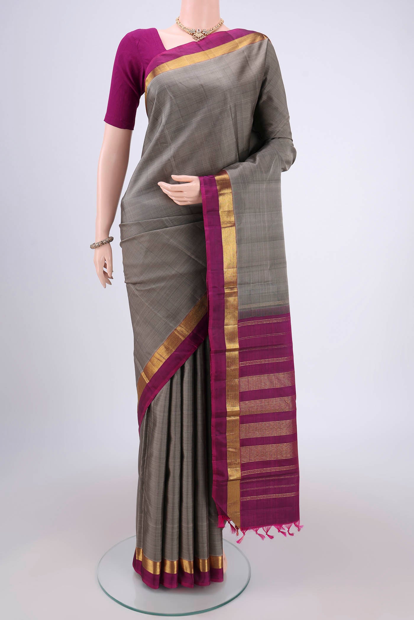 Grey Kanjivaram Silk Saree with Plain Body and Zari Border.  displayed on a mannequin