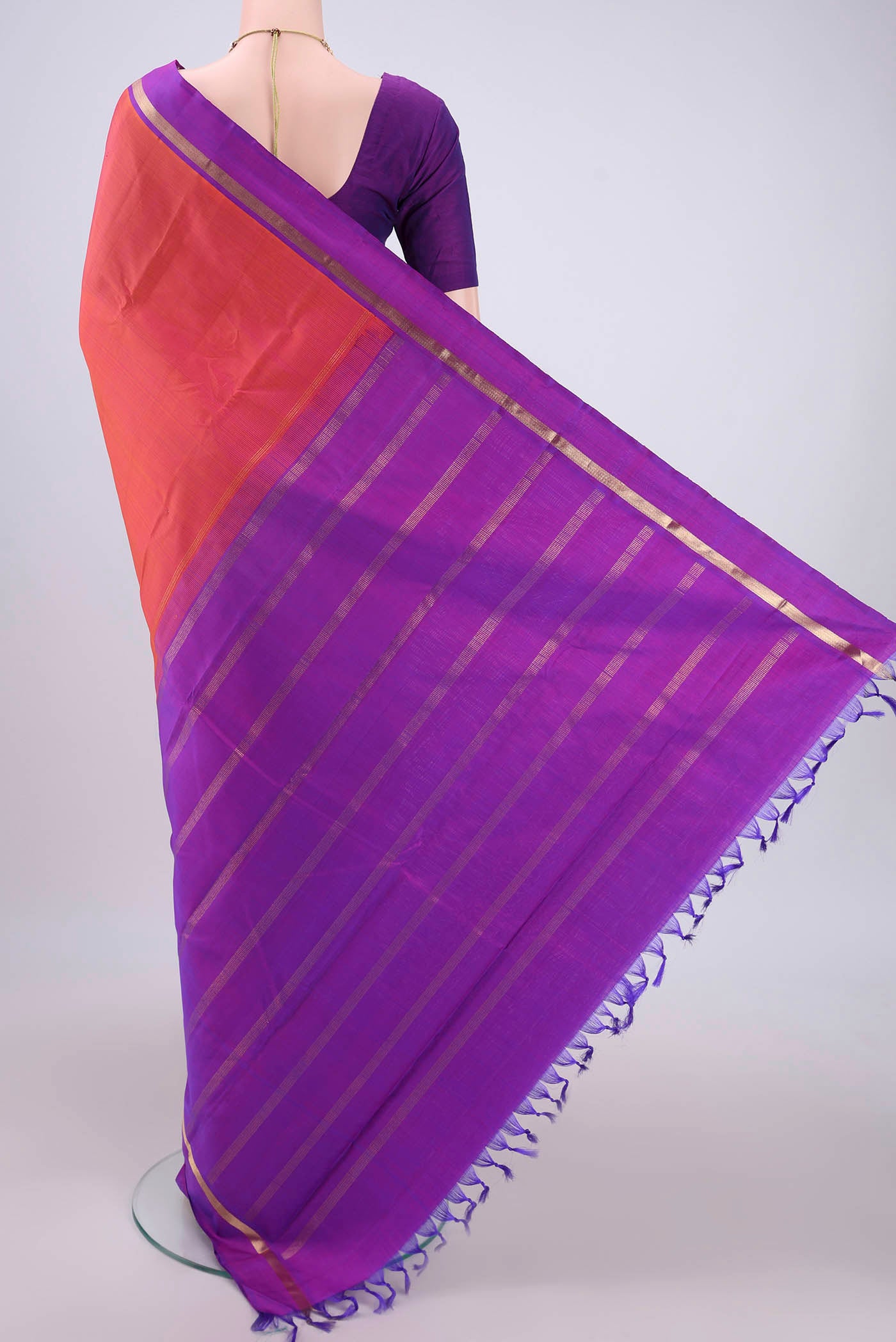 Flat view of Orange Kanjivaram Silk Saree with Plain Body and Zari Border. 